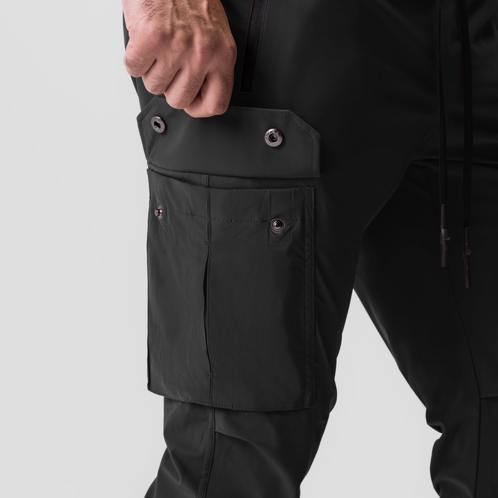 Tetra-Lite® Cargo High Rib Jogger in black, worn by model showing side cargo pocket detail