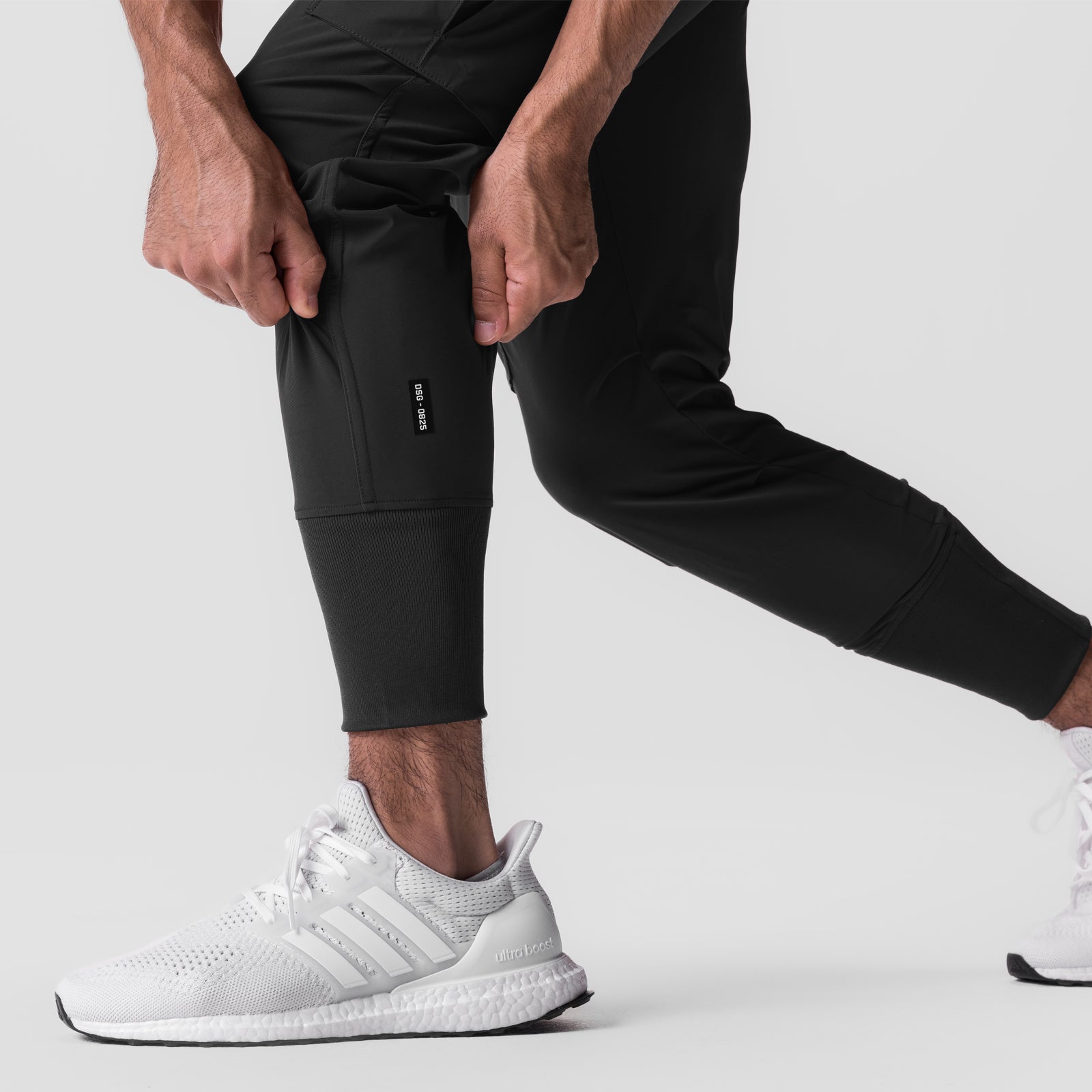 Tetra-Lite® Cargo High Rib Jogger in black, worn by model with white sneakers