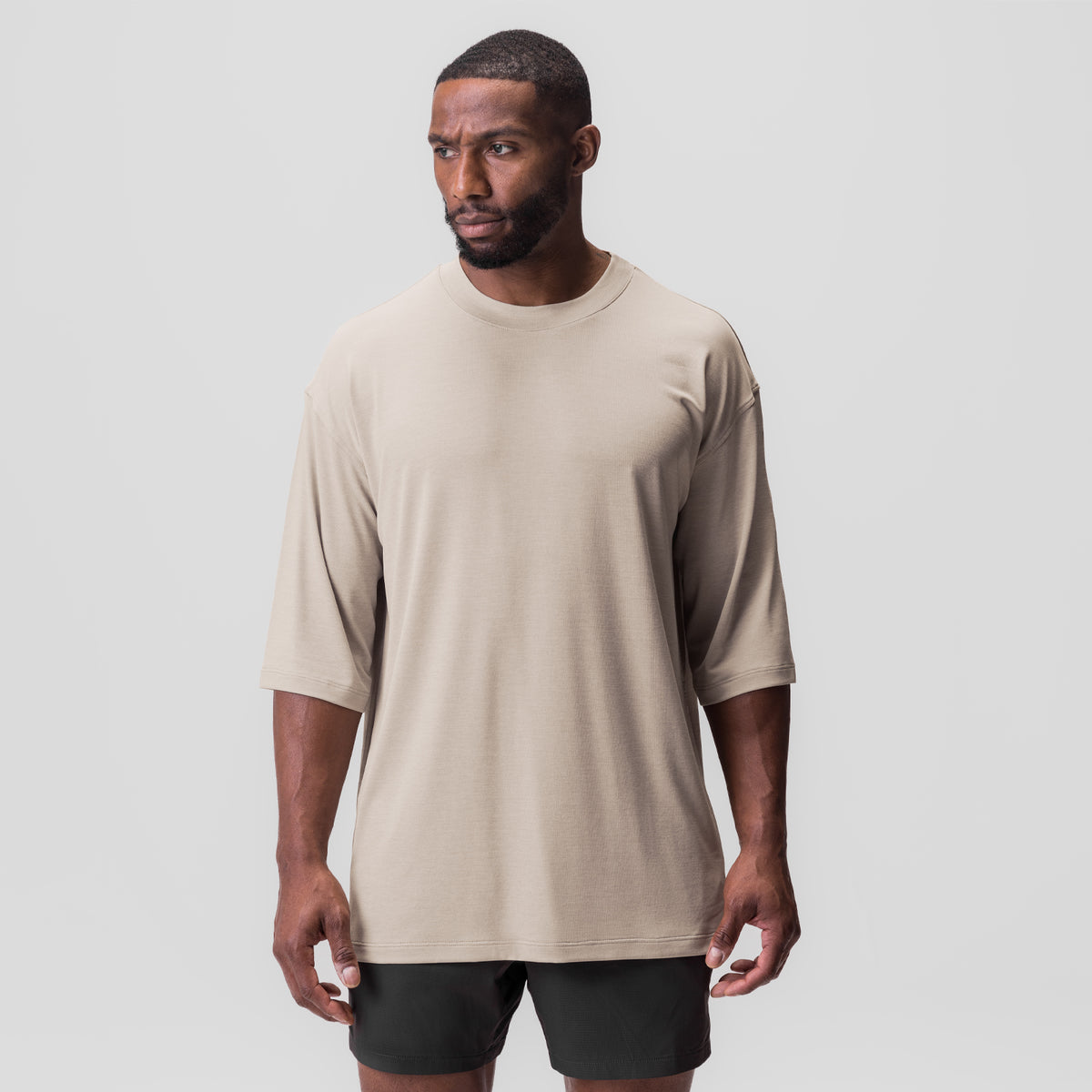 3D-Lite® 2.0 3/4-Sleeve Oversized Tee in Sand Smoke, worn with black shorts