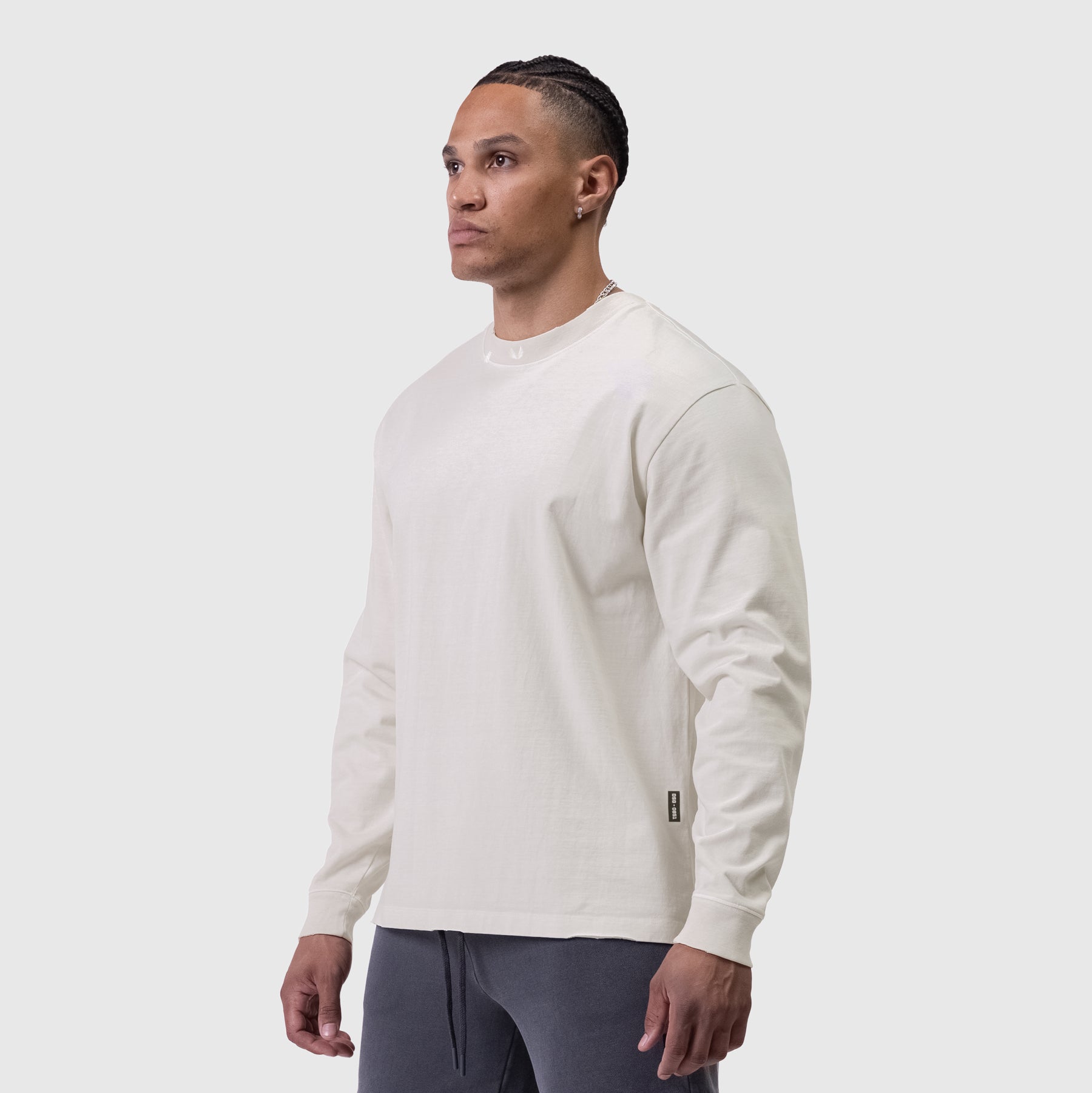 Tech Essential Relaxed Long Sleeve in faded stone, worn by model in side profile