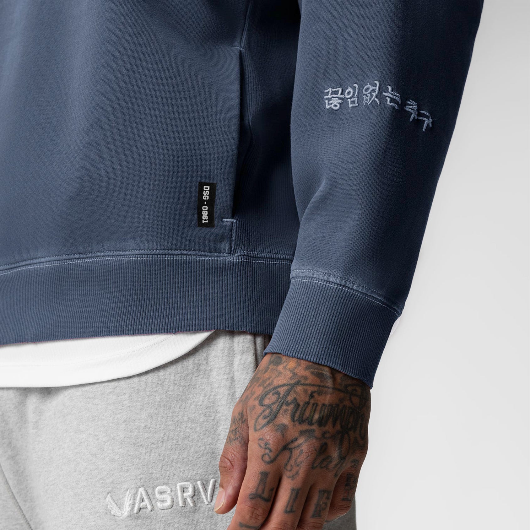 Tech Essential Distressed Crewneck in Faded Navy, worn by model showing sleeve and torso detail