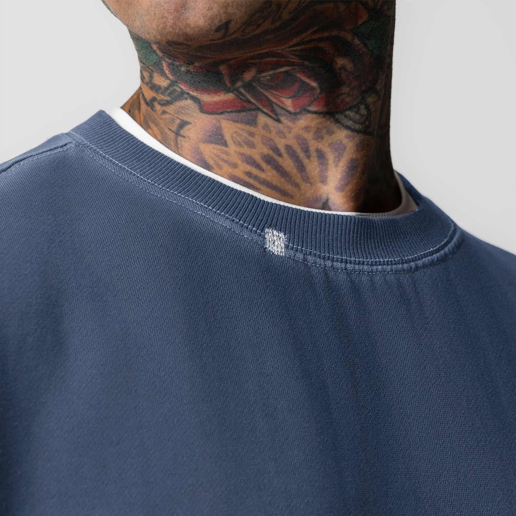 Tech Essential Distressed Crewneck in Faded Navy worn by model, neck detail view