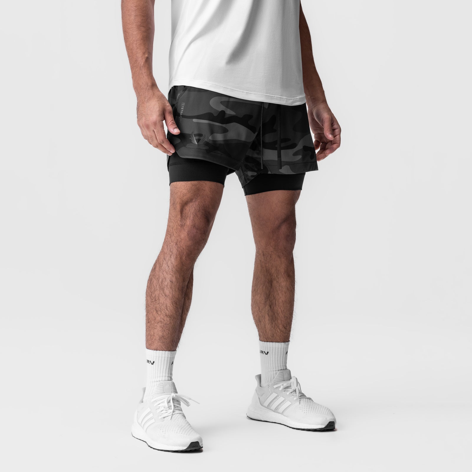 Tetra-Lite 5" Liner Short in Black Camo Wings, worn by model with white socks and sneakers