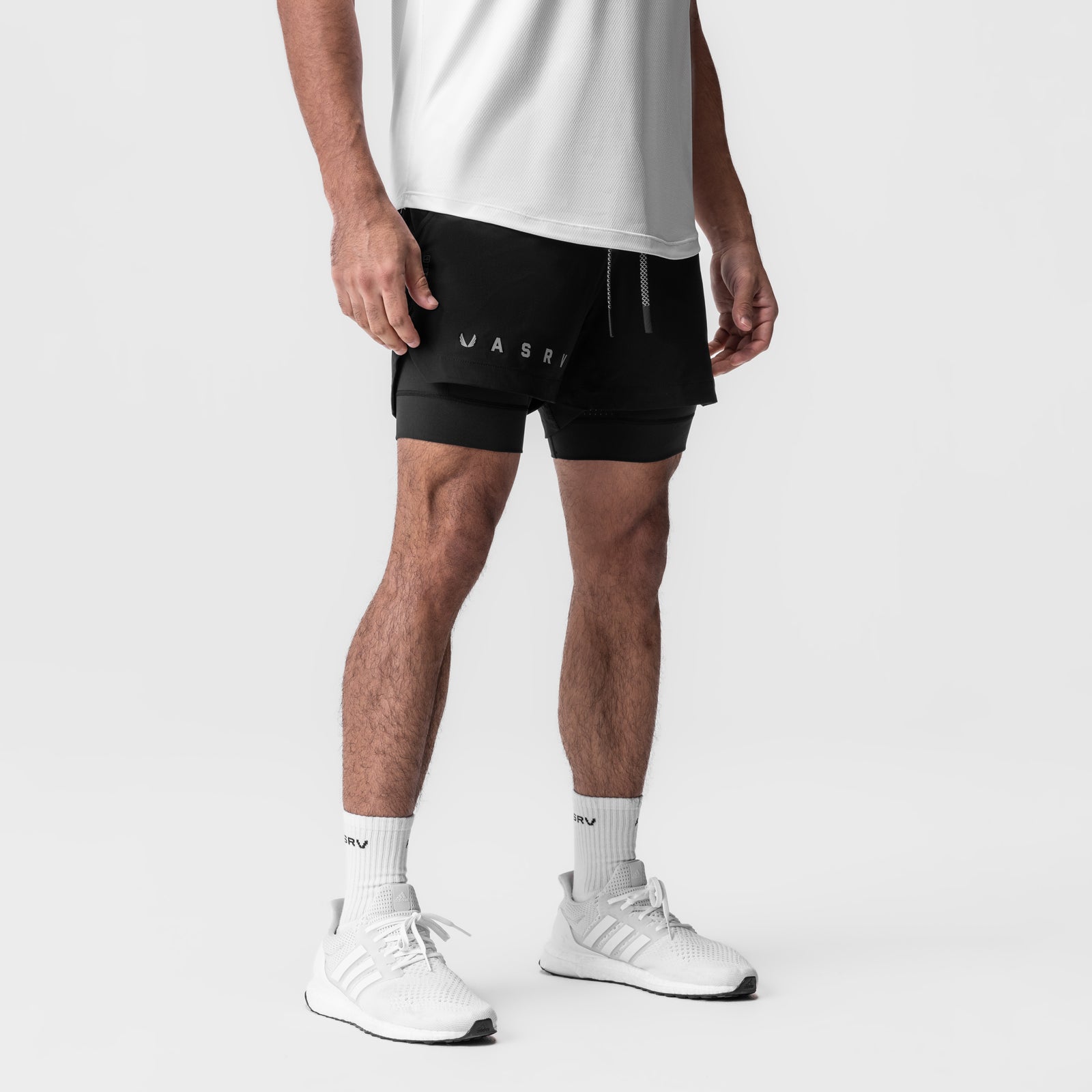 Tetra-Lite 5" Liner Short in black with reflective branding, modeled with white sneakers and socks