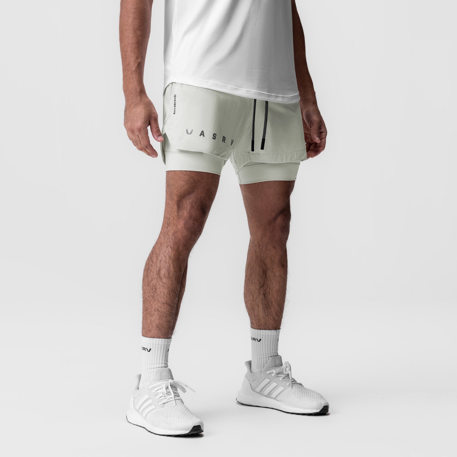 Tetra-Lite 5" Liner Short in stone, worn by model with white tee and sneakers, front view