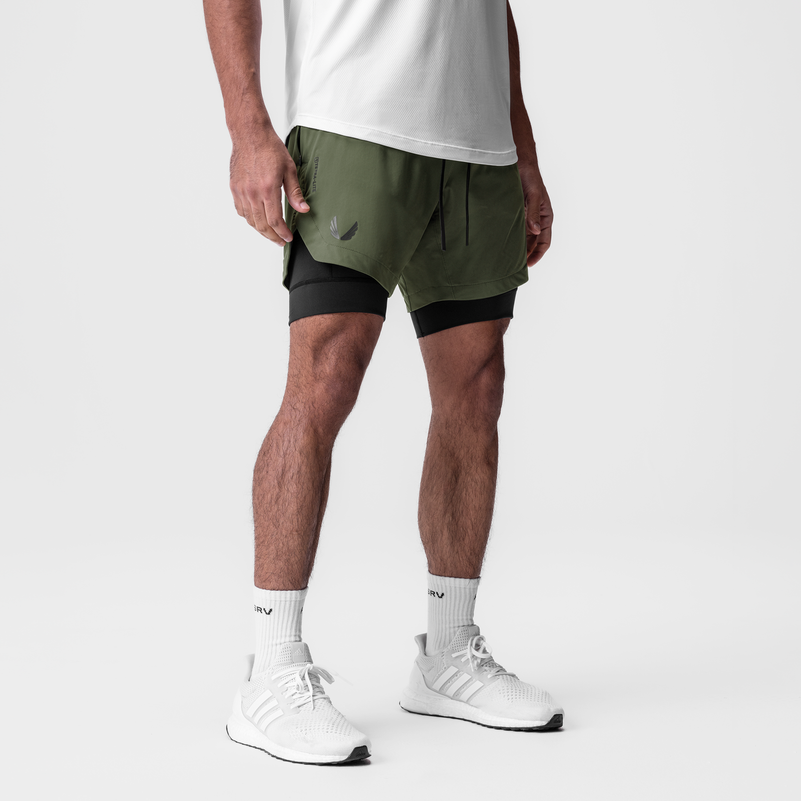 Tetra-Lite 7" Liner Short in olive and black worn with white socks and sneakers, side view