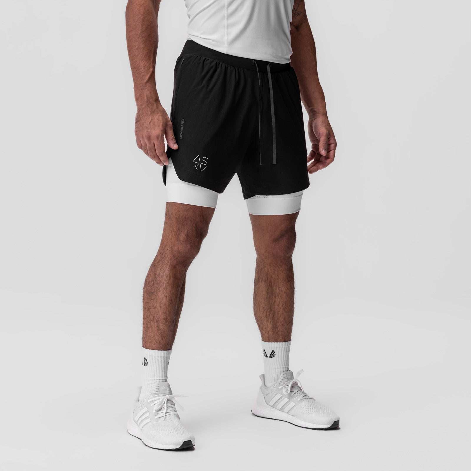 Tetra-Lite 7" Liner Short in Black and White, worn by male model with white socks and sneakers