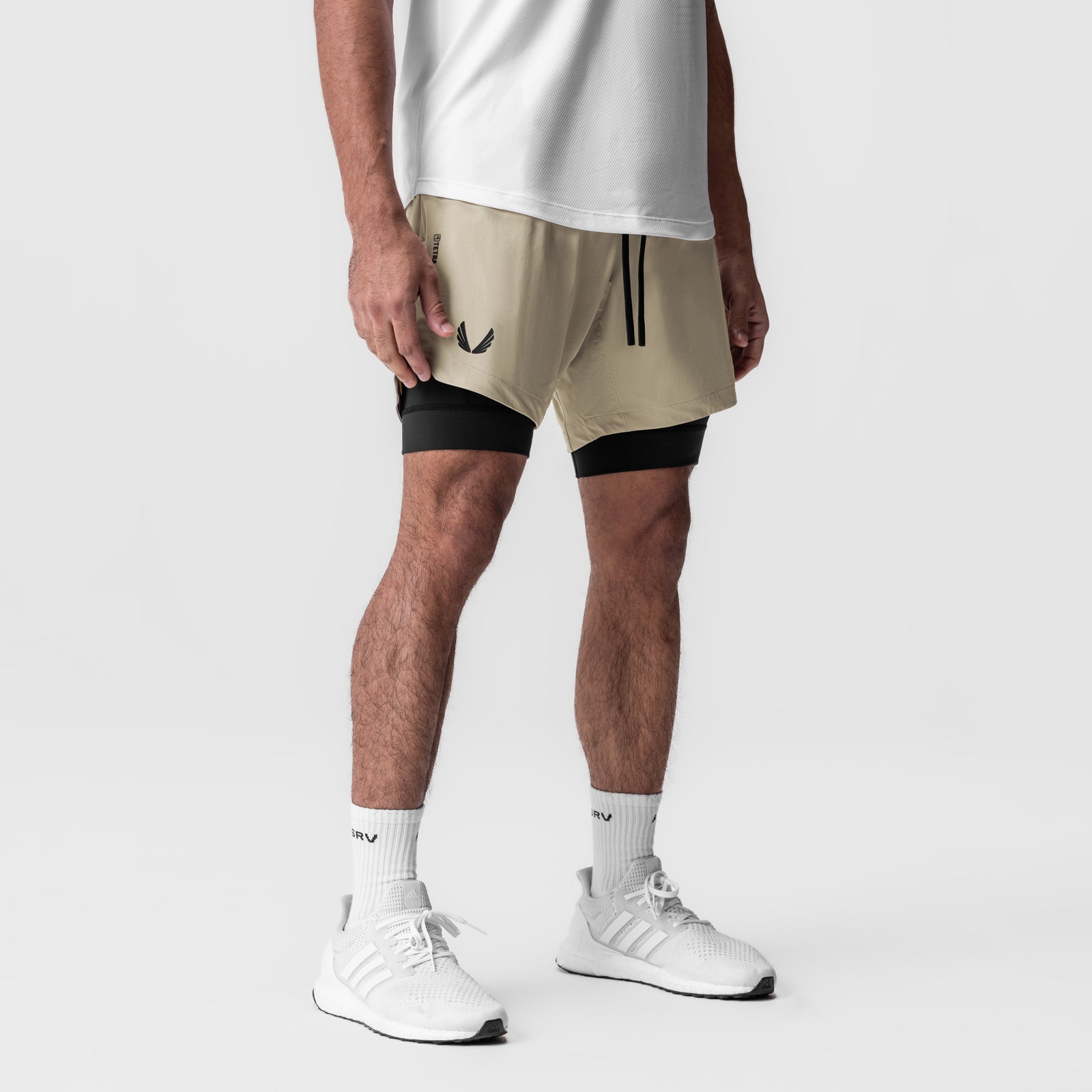 Tetra-Lite 7" Liner Short in sand and black, worn with white socks and sneakers