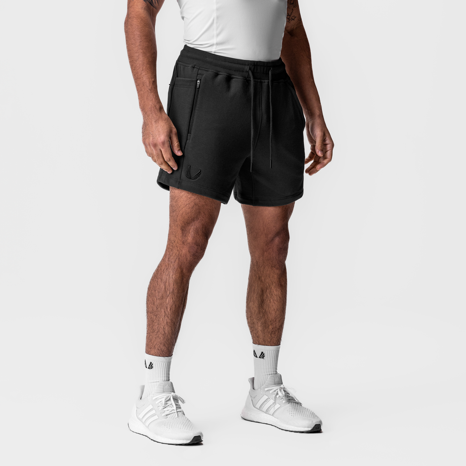 Black Tech-Terry Sidelock Sweat Shorts on model, front view with white sneakers