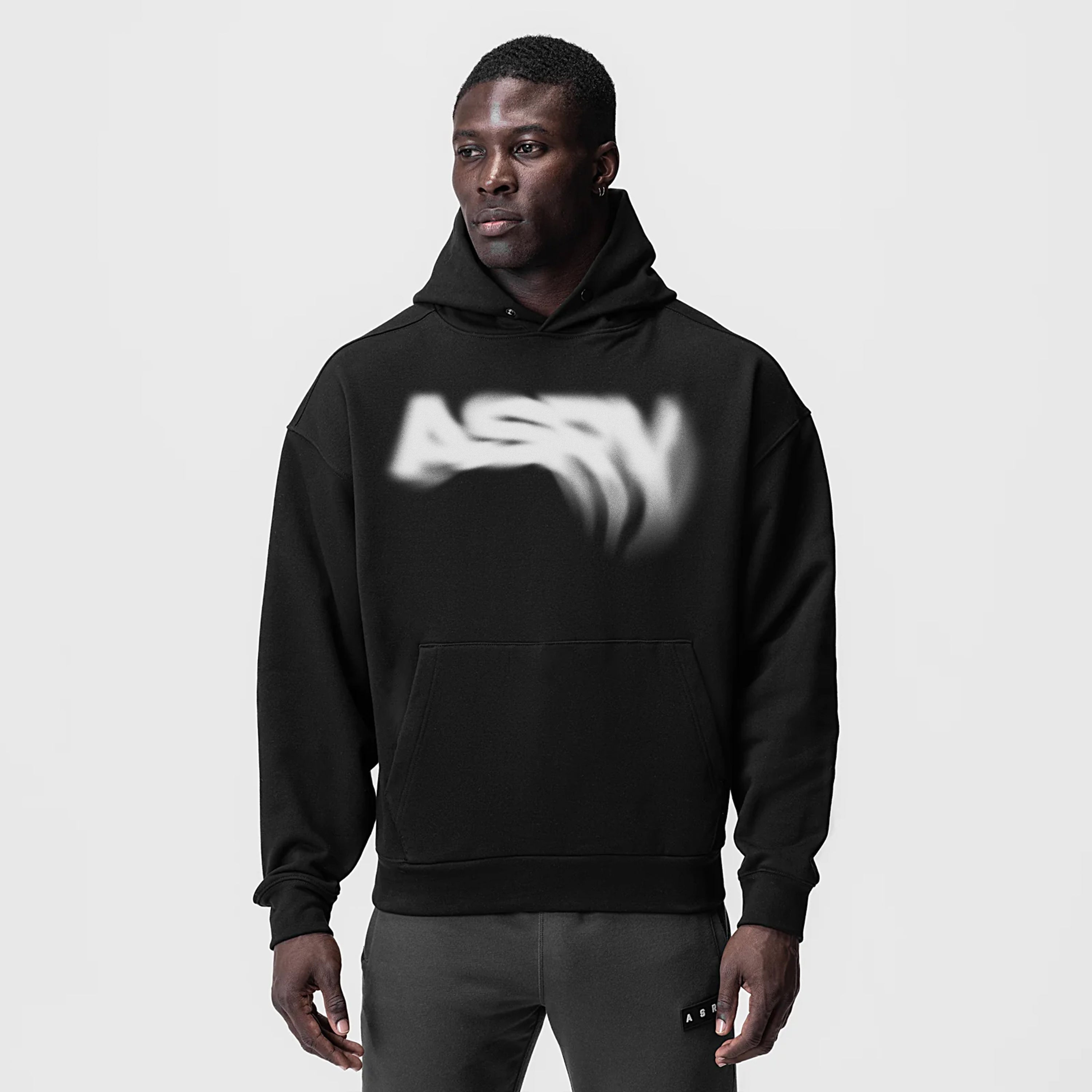 Tech-Terry Zip Pocket Hoodie in black with blurred graphic design, front view on model