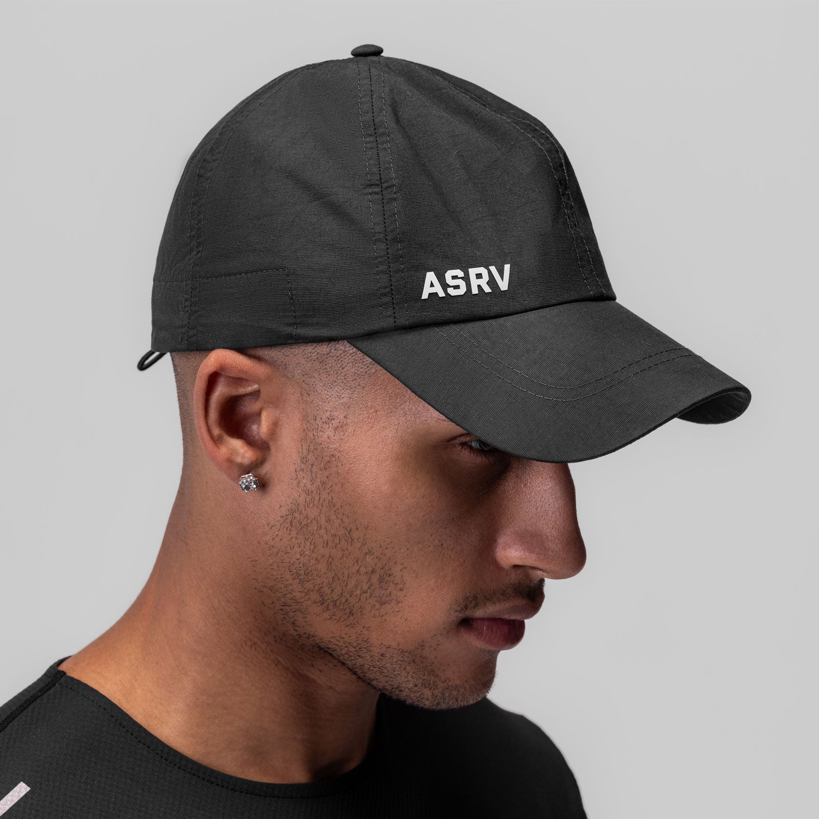 Weather-Ready Cinch Hat in black worn by model in profile view