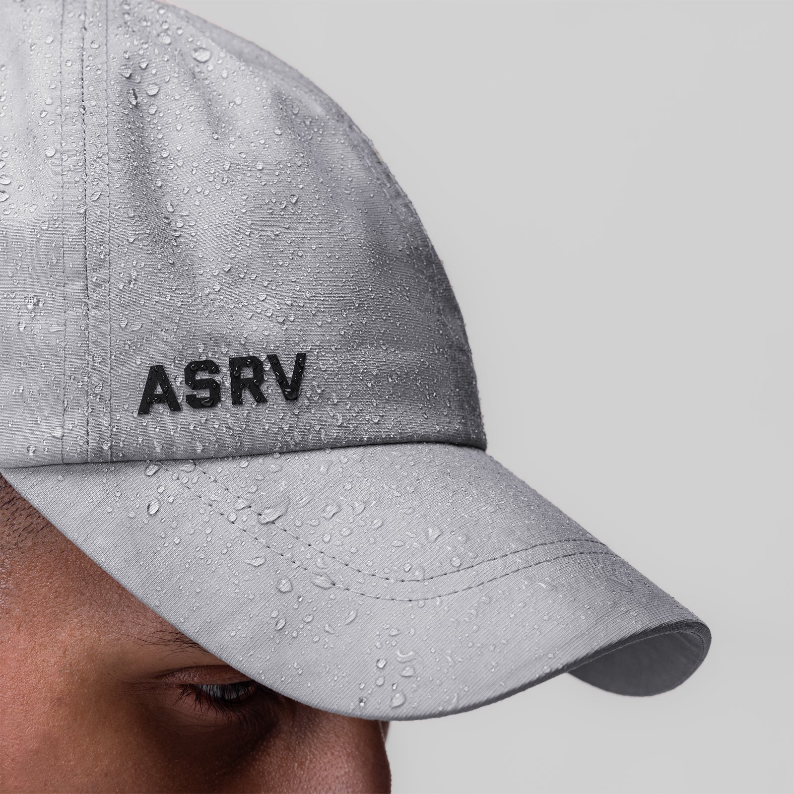 Weather-Ready Cinch Hat in grey worn by model, side view showing water-resistant fabric