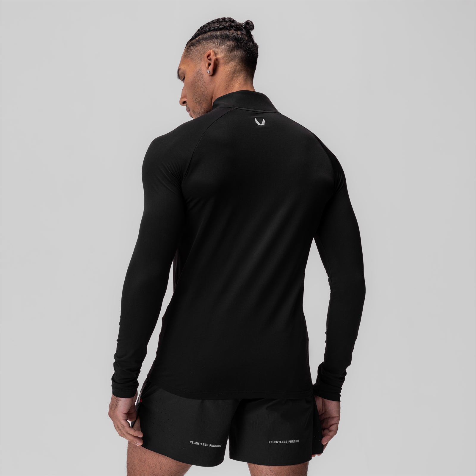 Black thermal training quarter zip worn by model, back view