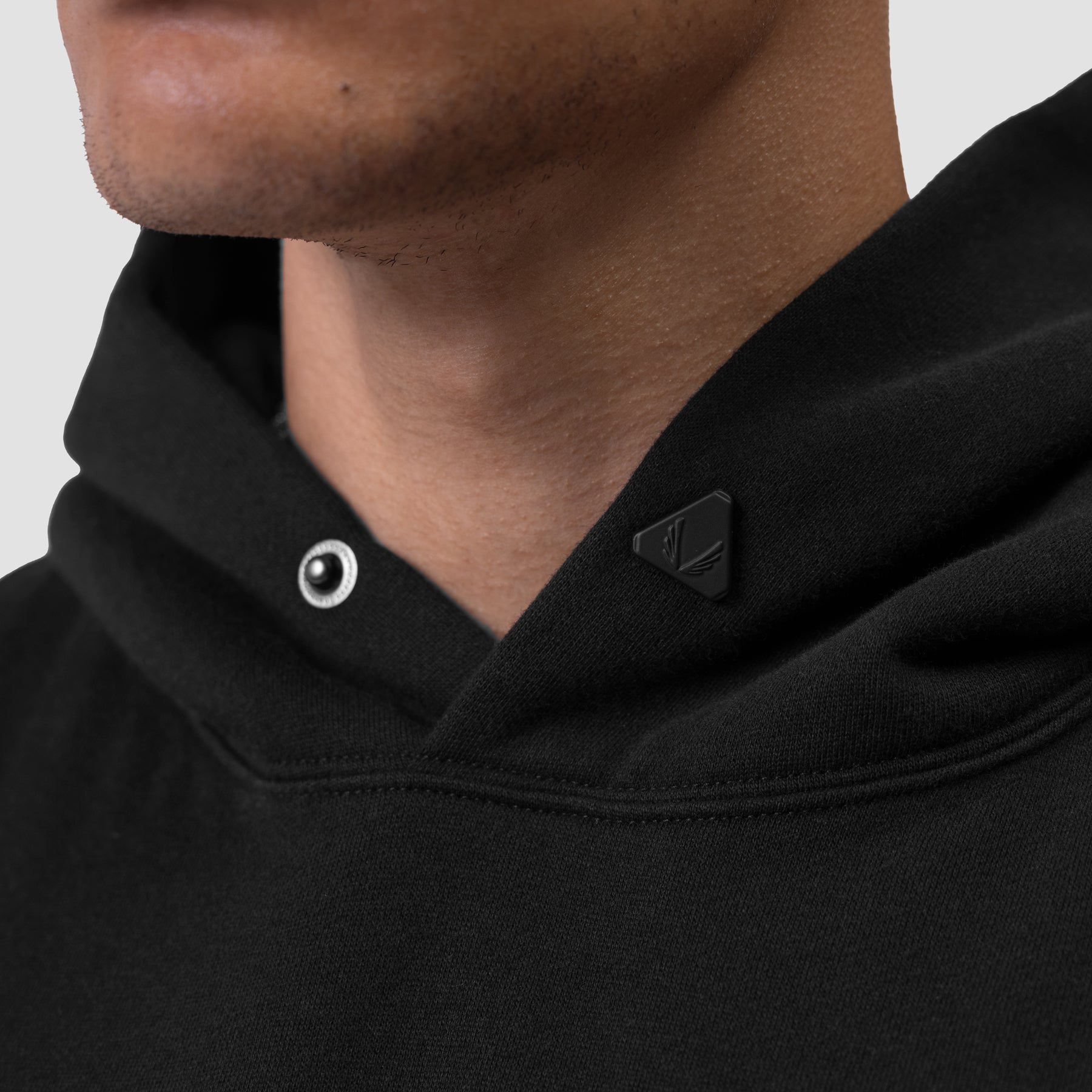 Tech Essential Distressed Hoodie in black, worn by model, neckline detail view