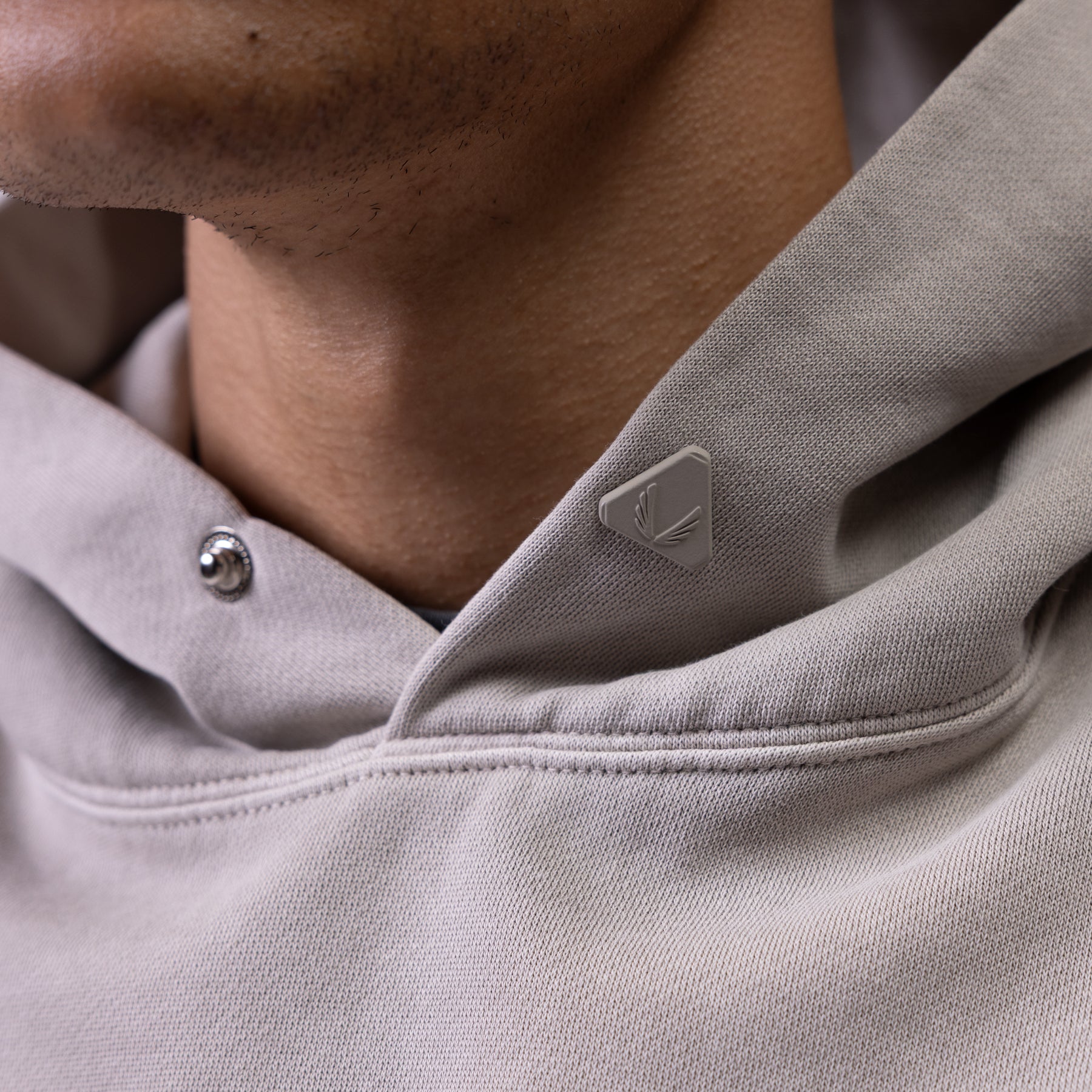 Tech Essential Distressed Hoodie in Faded Chai worn by model, close-up detail shot