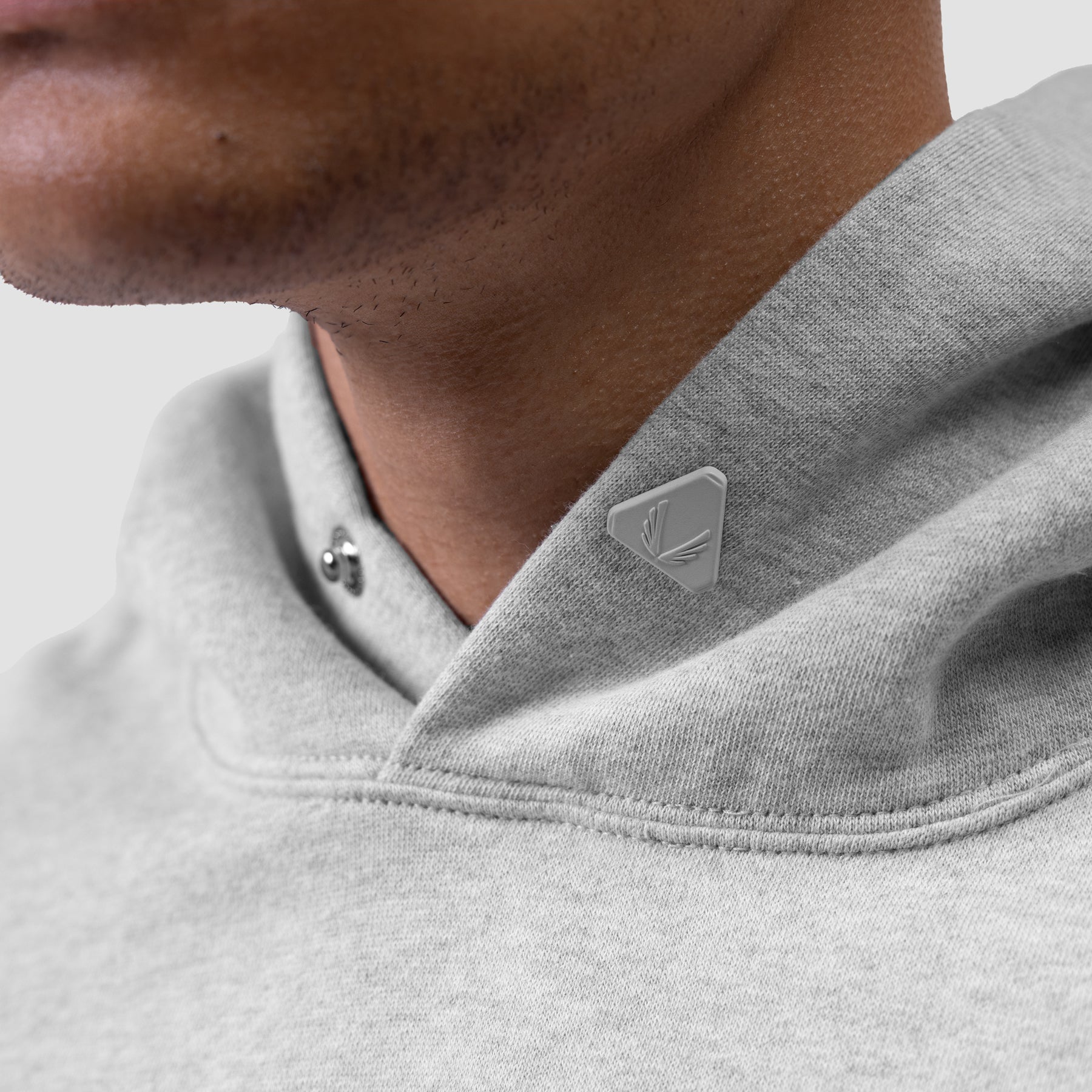 Tech Essential Distressed Hoodie in Heather Grey, worn by model, chest detail