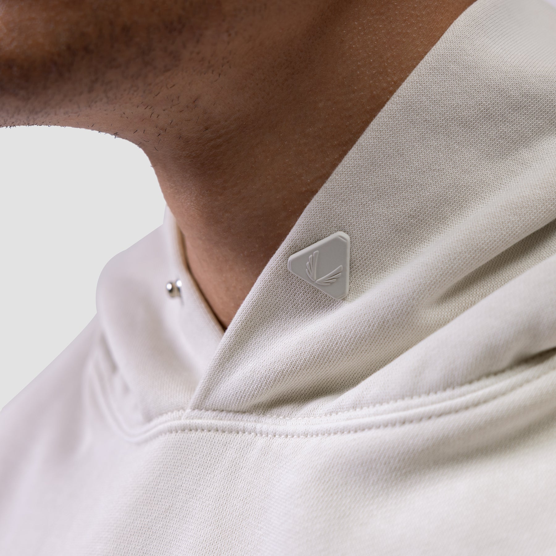 Tech Essential Distressed Hoodie in Faded Stone, worn by model showing shoulder and chest detail