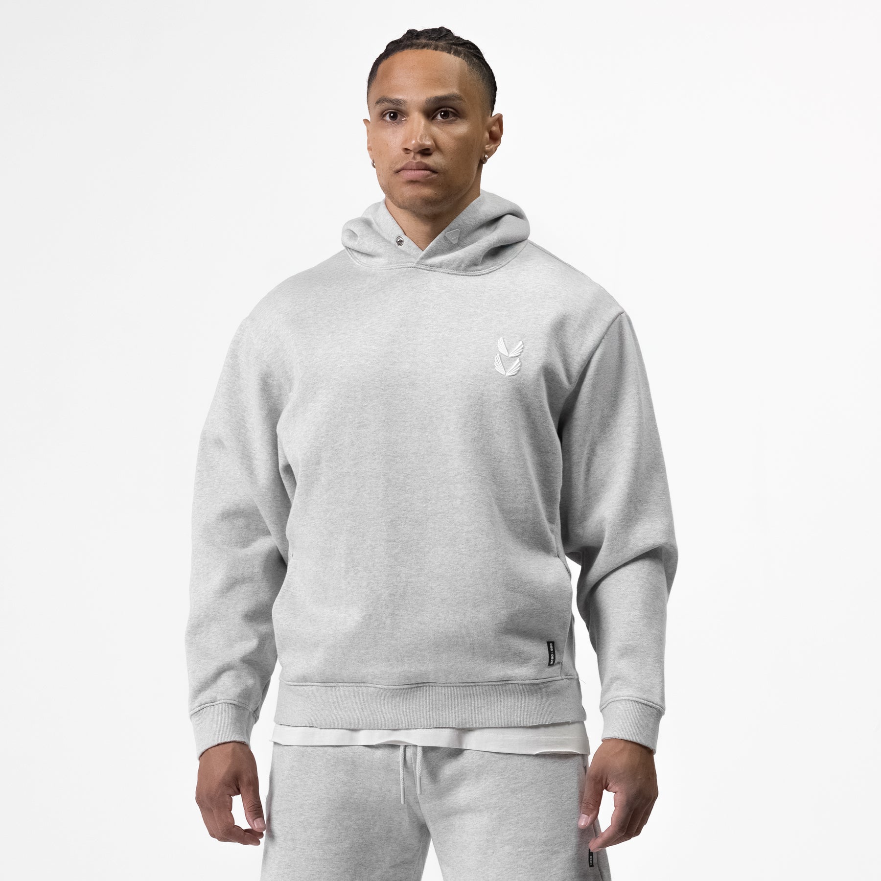 Tech Essential Distressed Hoodie in heather grey, worn by model, front view