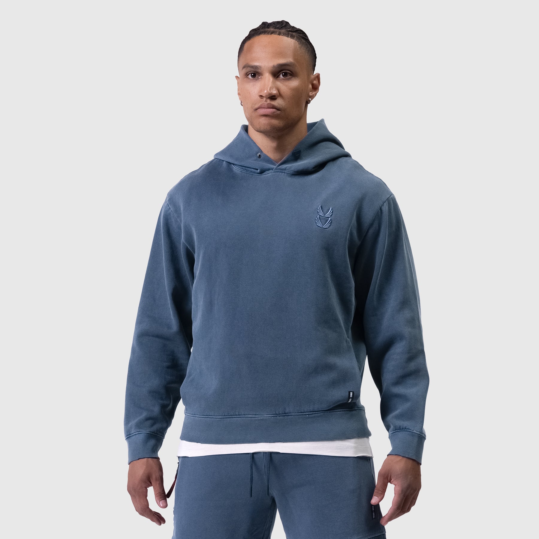 Tech Essential Distressed Hoodie in faded navy worn by model, front view