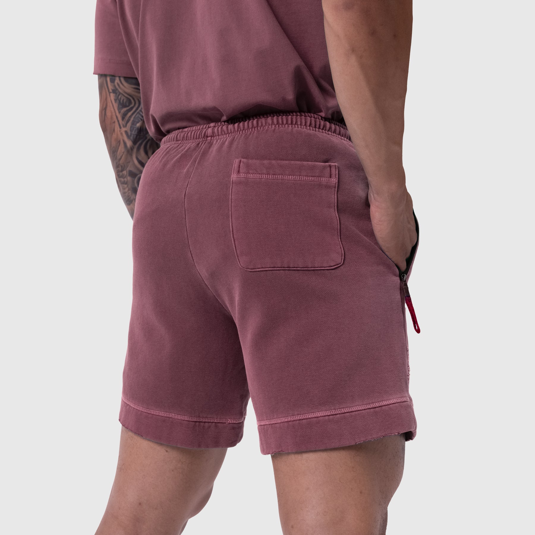 Tech Essential Sweat Short in Faded Crimson worn by model, back view