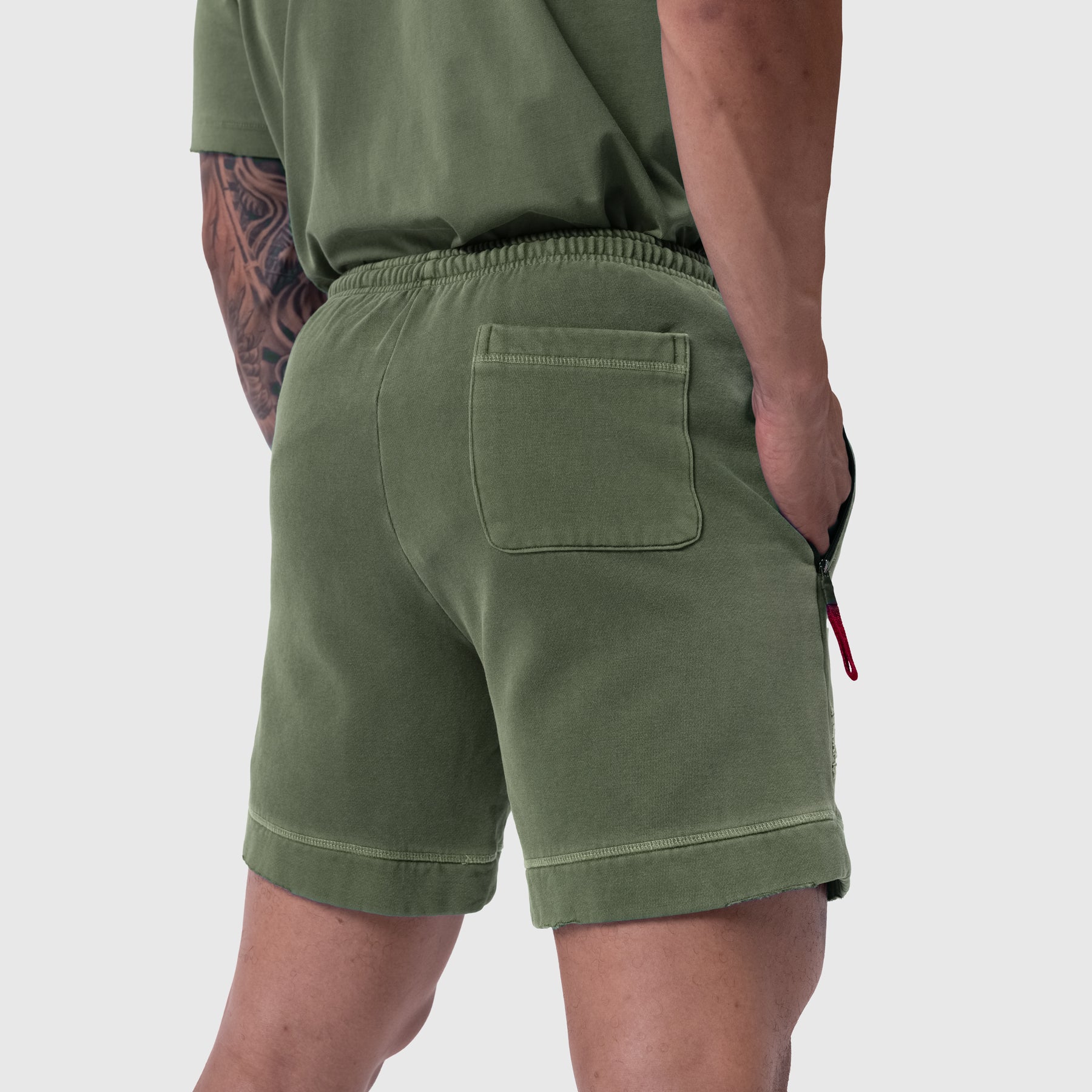 Tech Essential Sweat Short in Faded Olive worn by model, back view