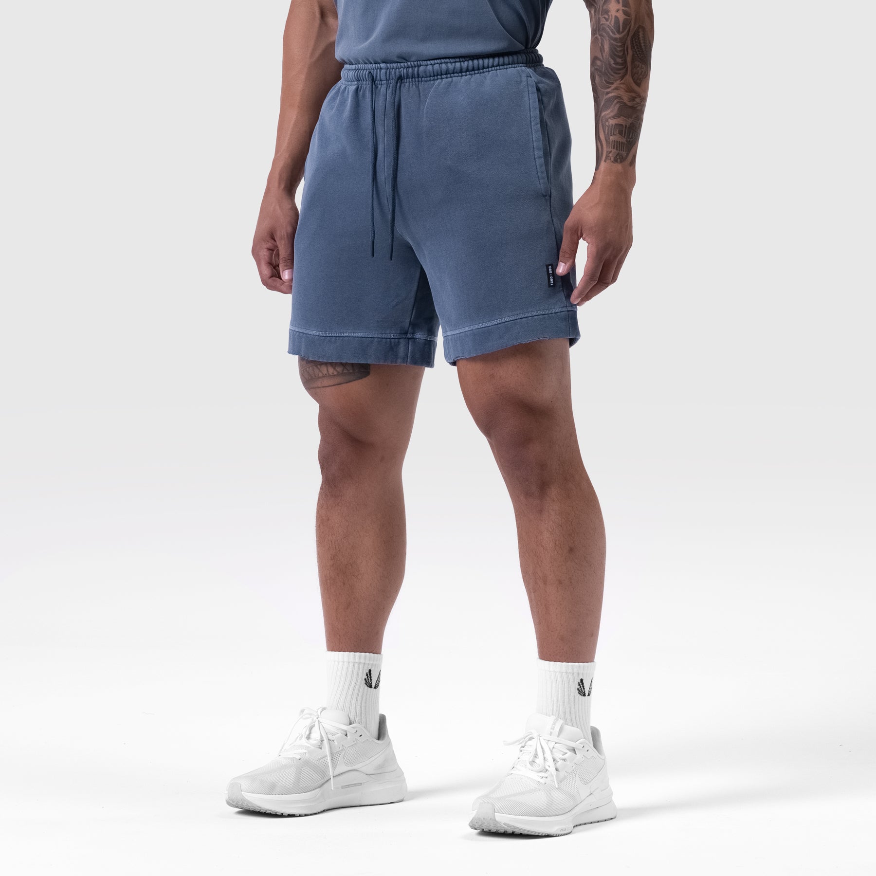 Tech Essential Sweat Short in Faded Navy worn by model, front view