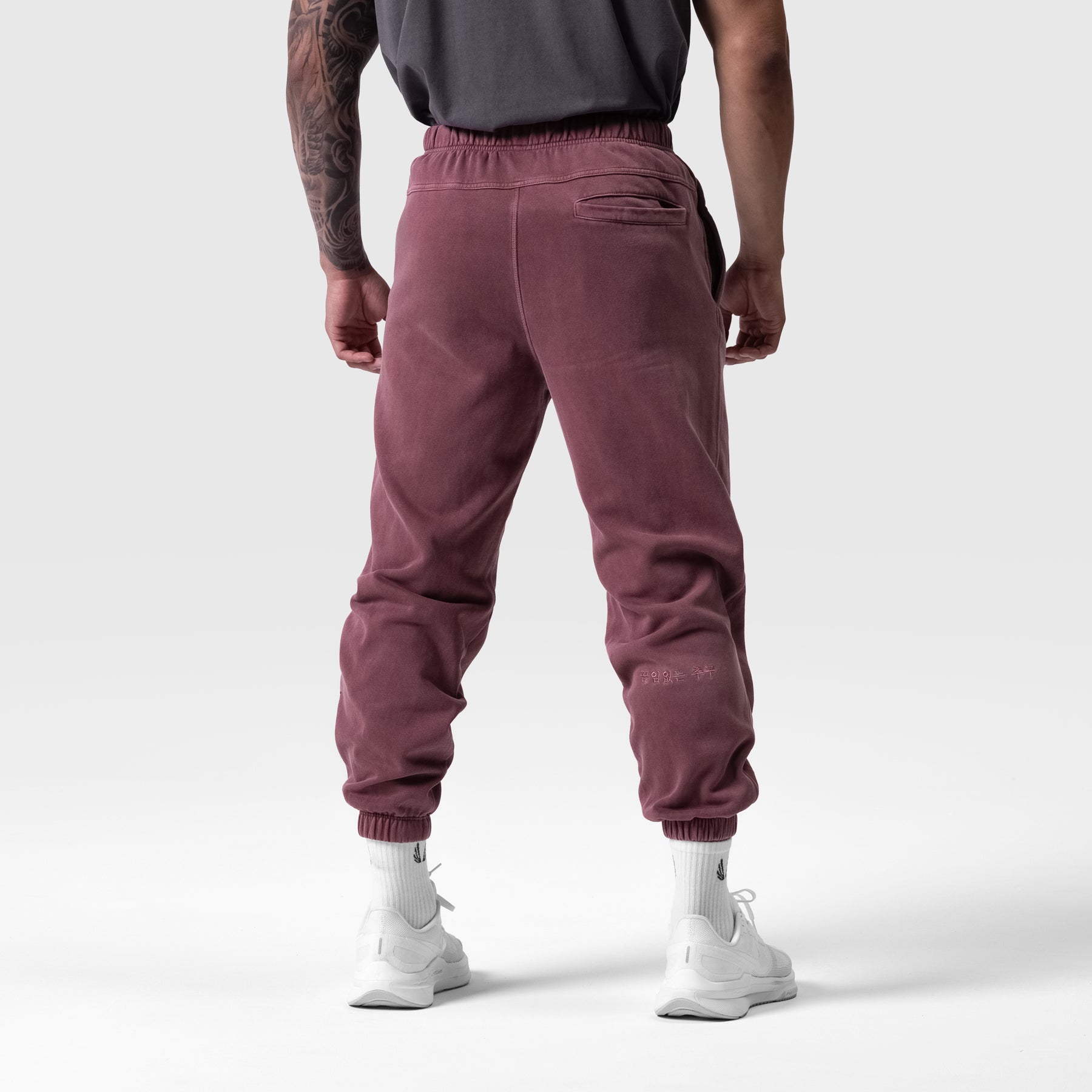 Tech Essential Sweats in Faded Crimson, back view on model wearing white socks and sneakers
