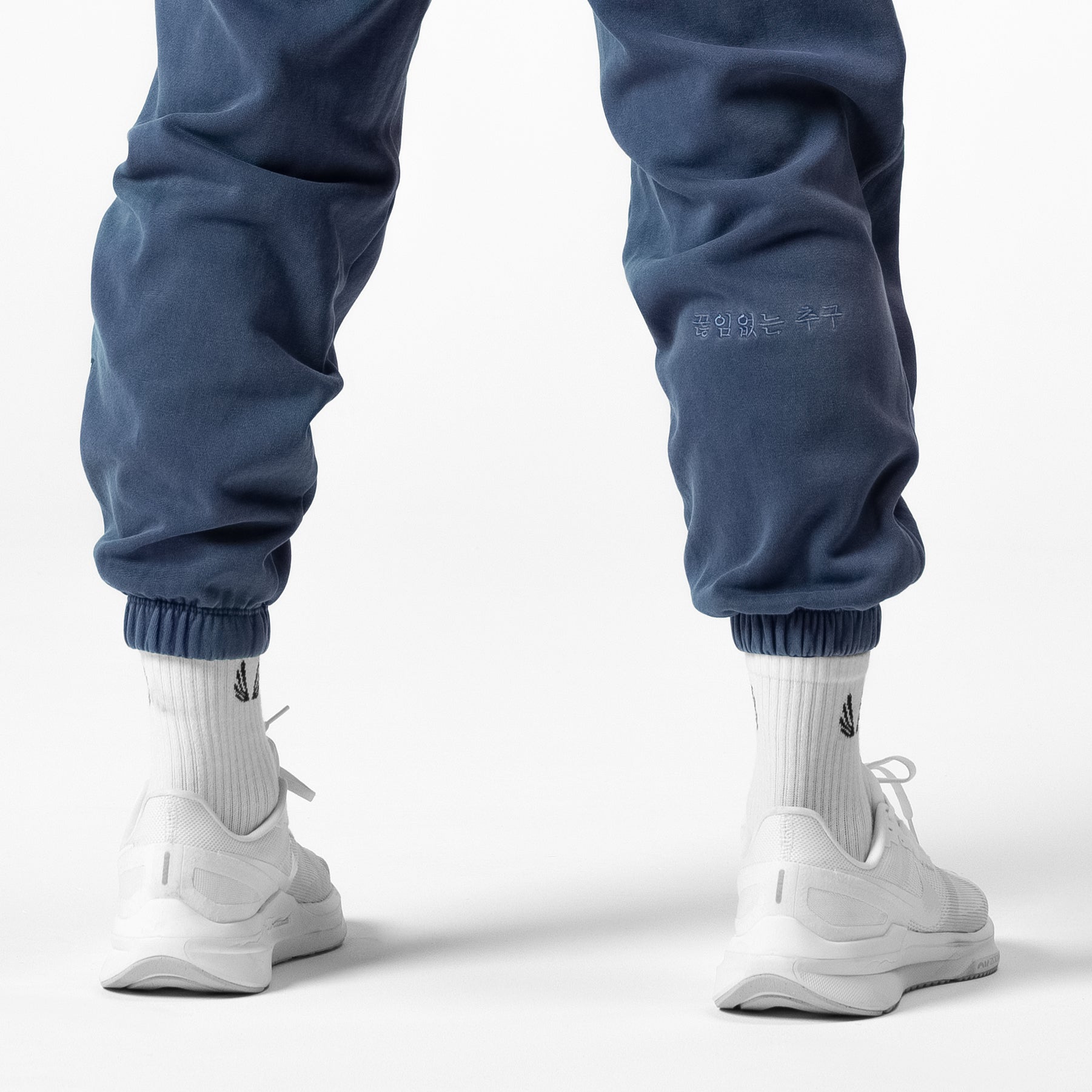 Tech Essential™ Sweats in faded navy worn with white socks and sneakers, back view
