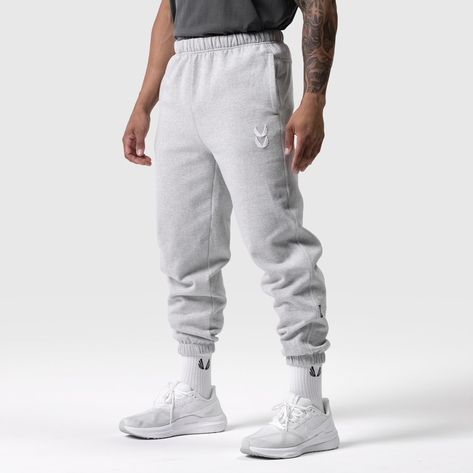 Tech Essential Sweats in heather grey worn by model, full-length side view