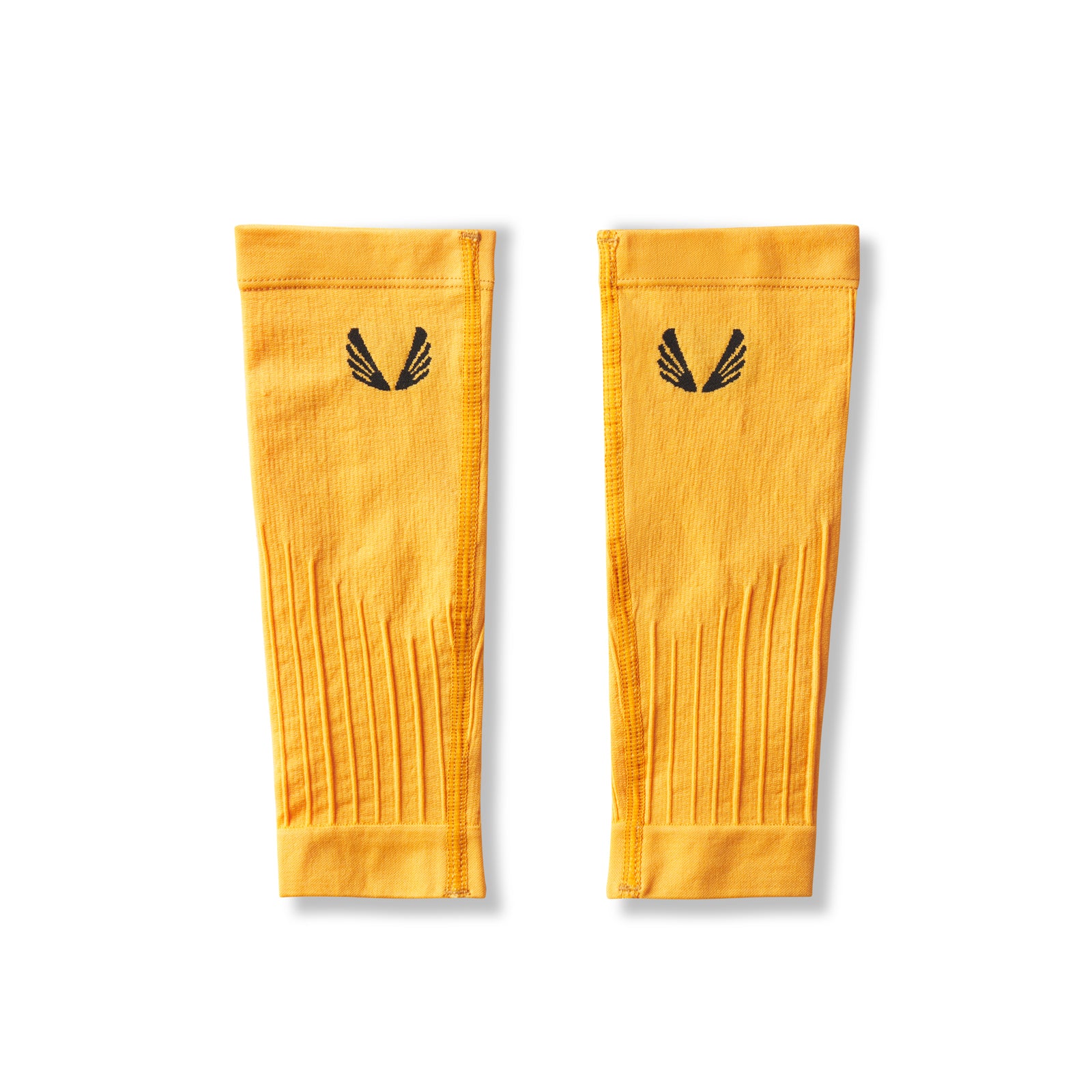 Flatlay of Body-Mapped Calf Sleeve in amber yellow with striped texture detail, laid flat on white background