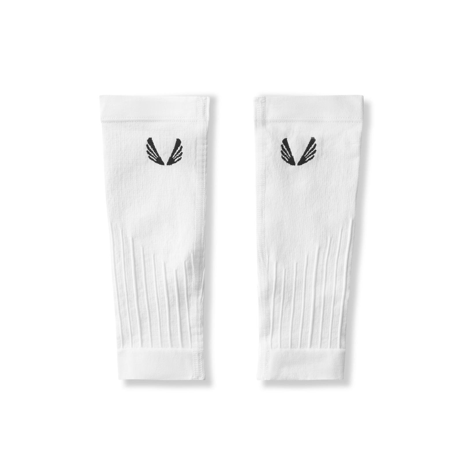 Flatlay of white body-mapped calf sleeves with black logo, displayed as a pair