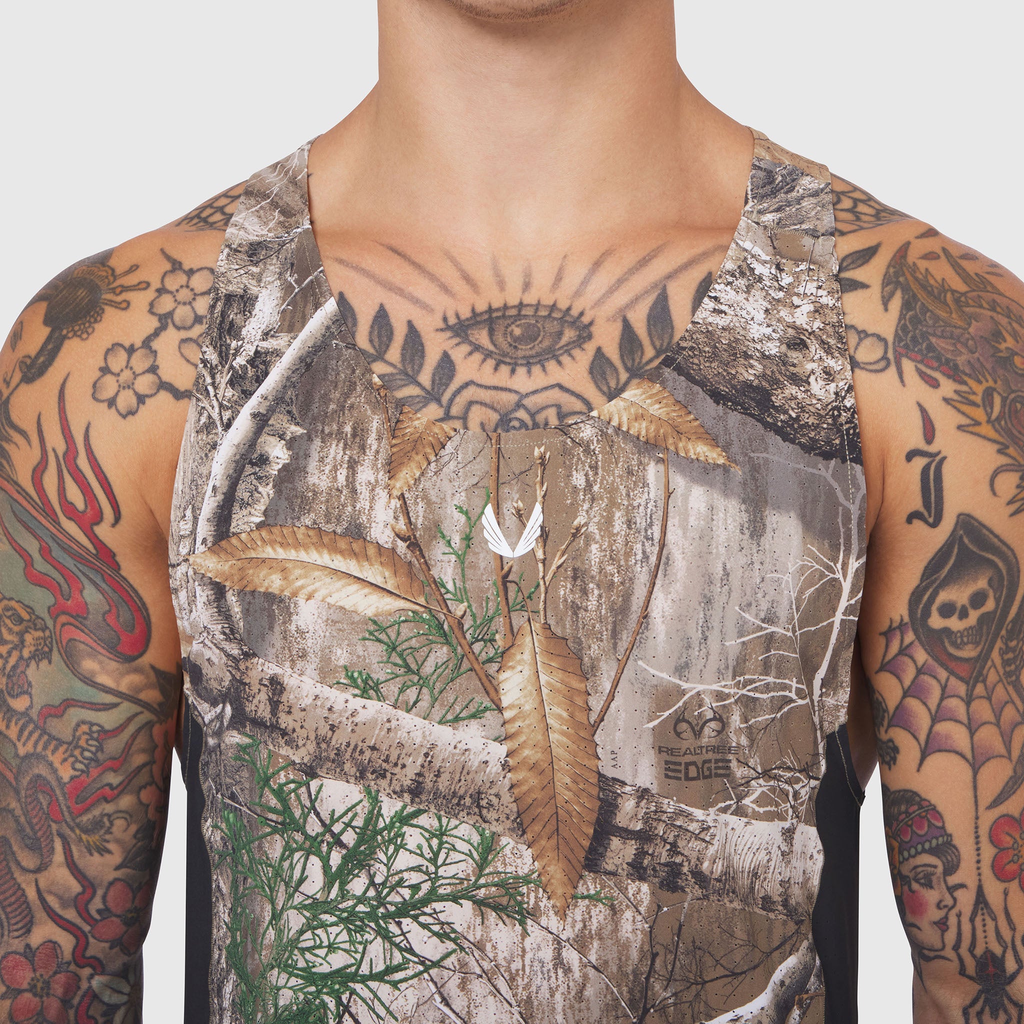 Laser-Vent Singlet Tank in Realtree Edge camo, worn by tattooed model, front view