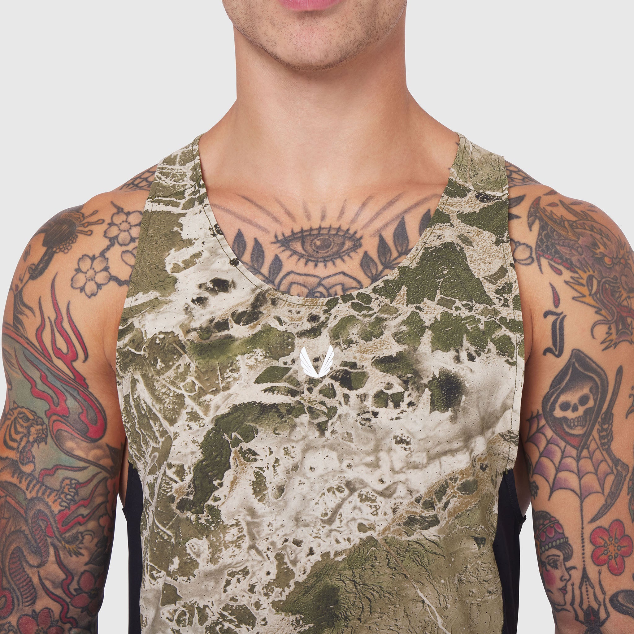 Laser-Vent Singlet Tank in olive camo print, worn by tattooed male model, front view