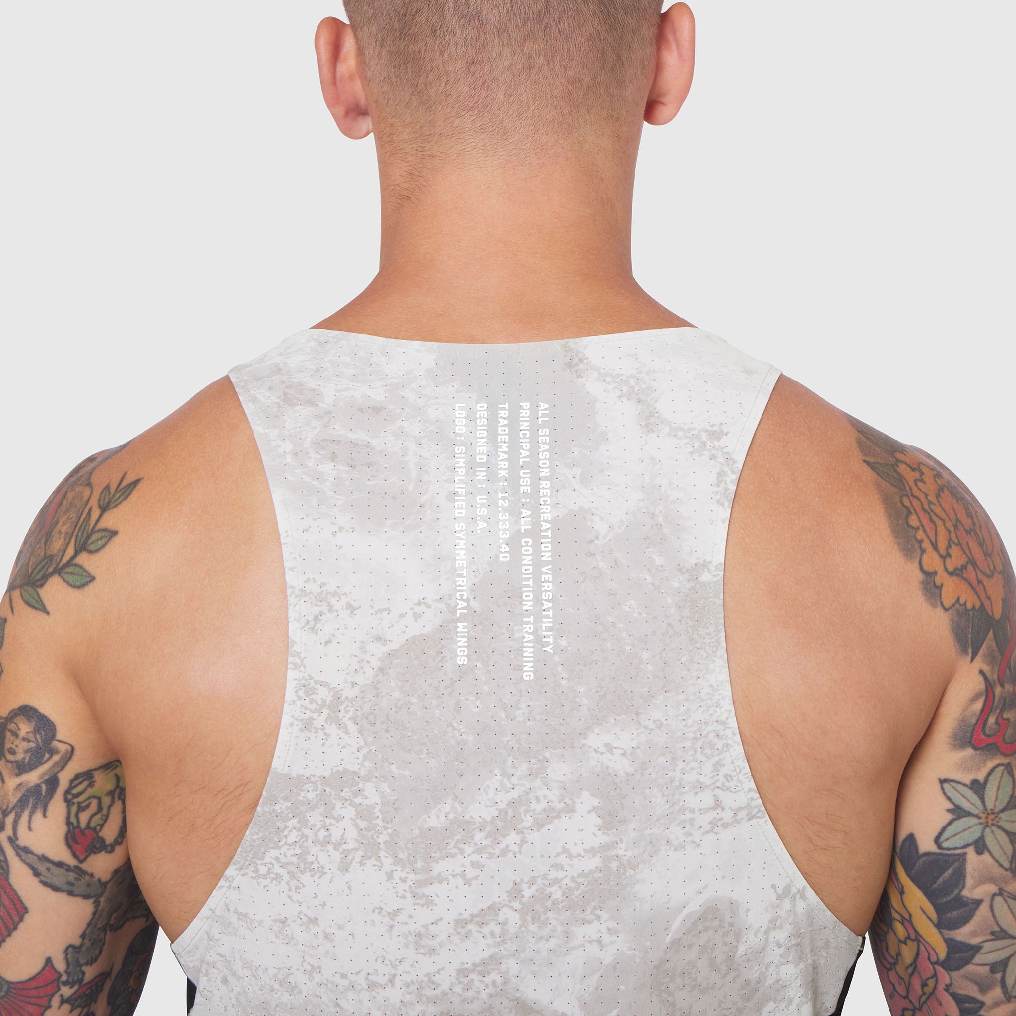 Laser-Vent Singlet Tank in light grey worn by tattooed model, back view