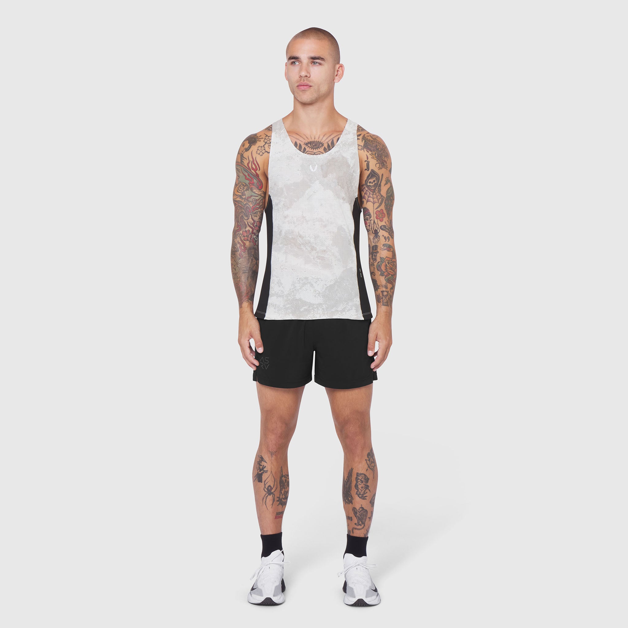 Laser-Vent Singlet Tank in white with black sides, worn by model with full-body front view