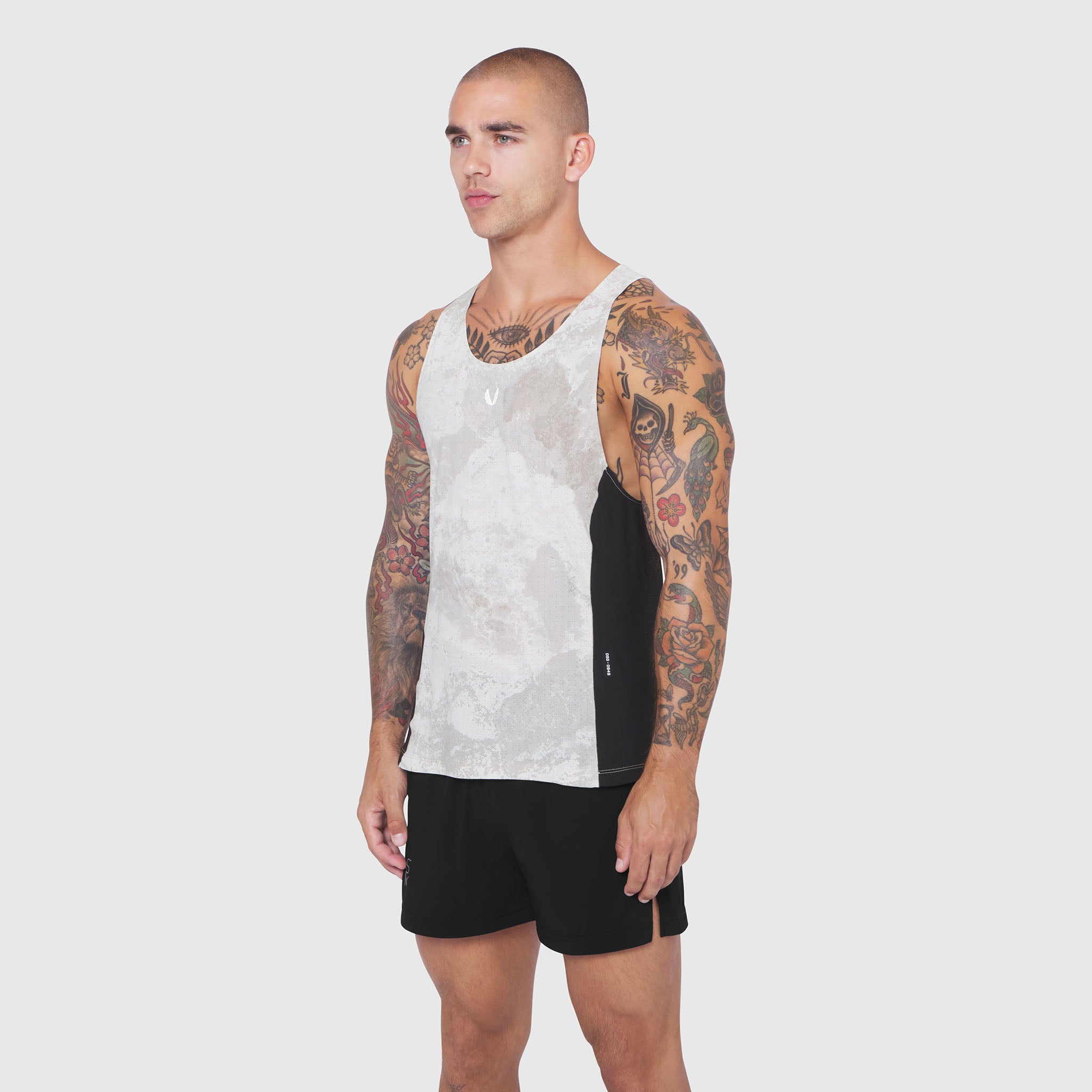 Laser-Vent Singlet Tank in white and black, worn by model showing front side view