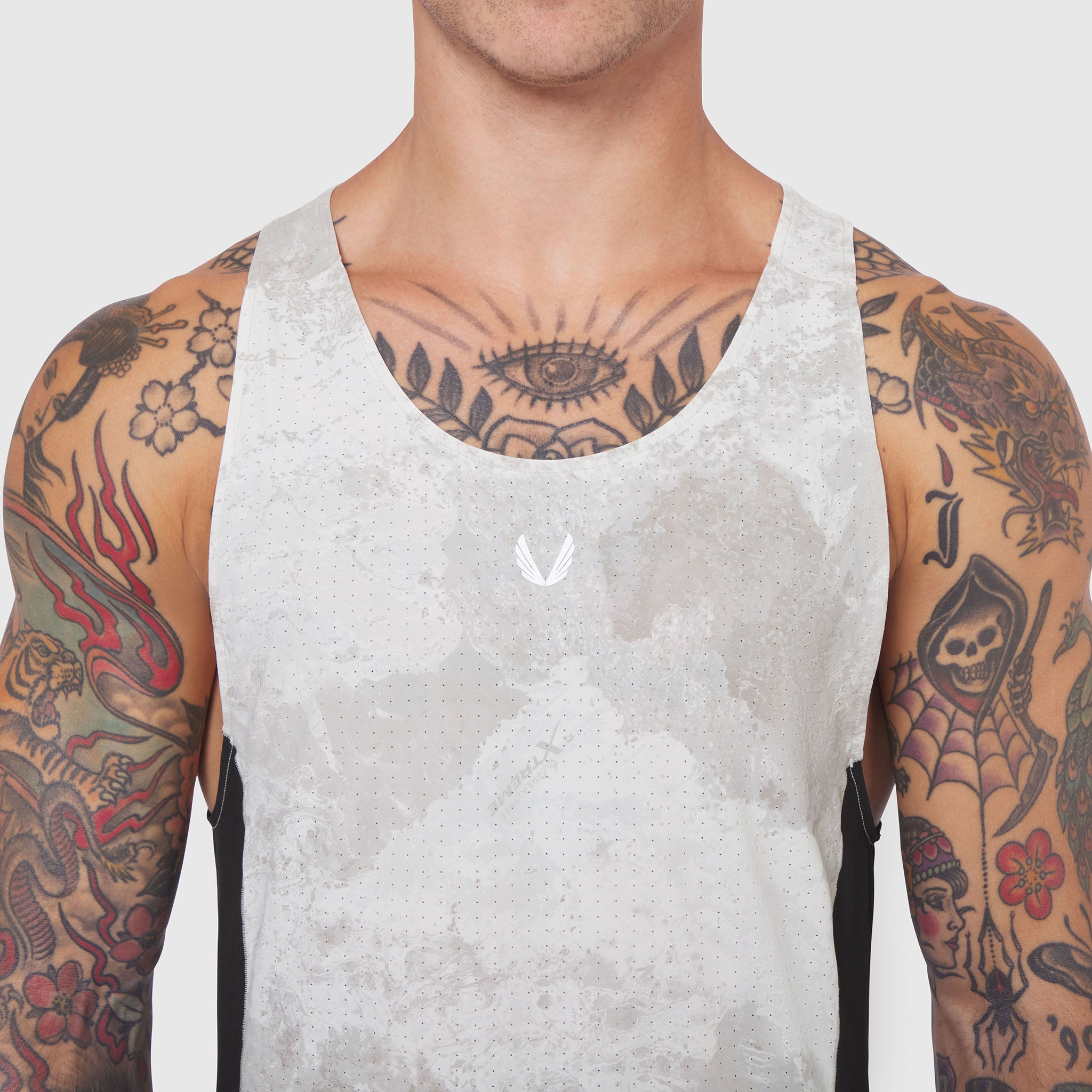 Laser-Vent Singlet Tank in white, worn by tattooed male model, front view