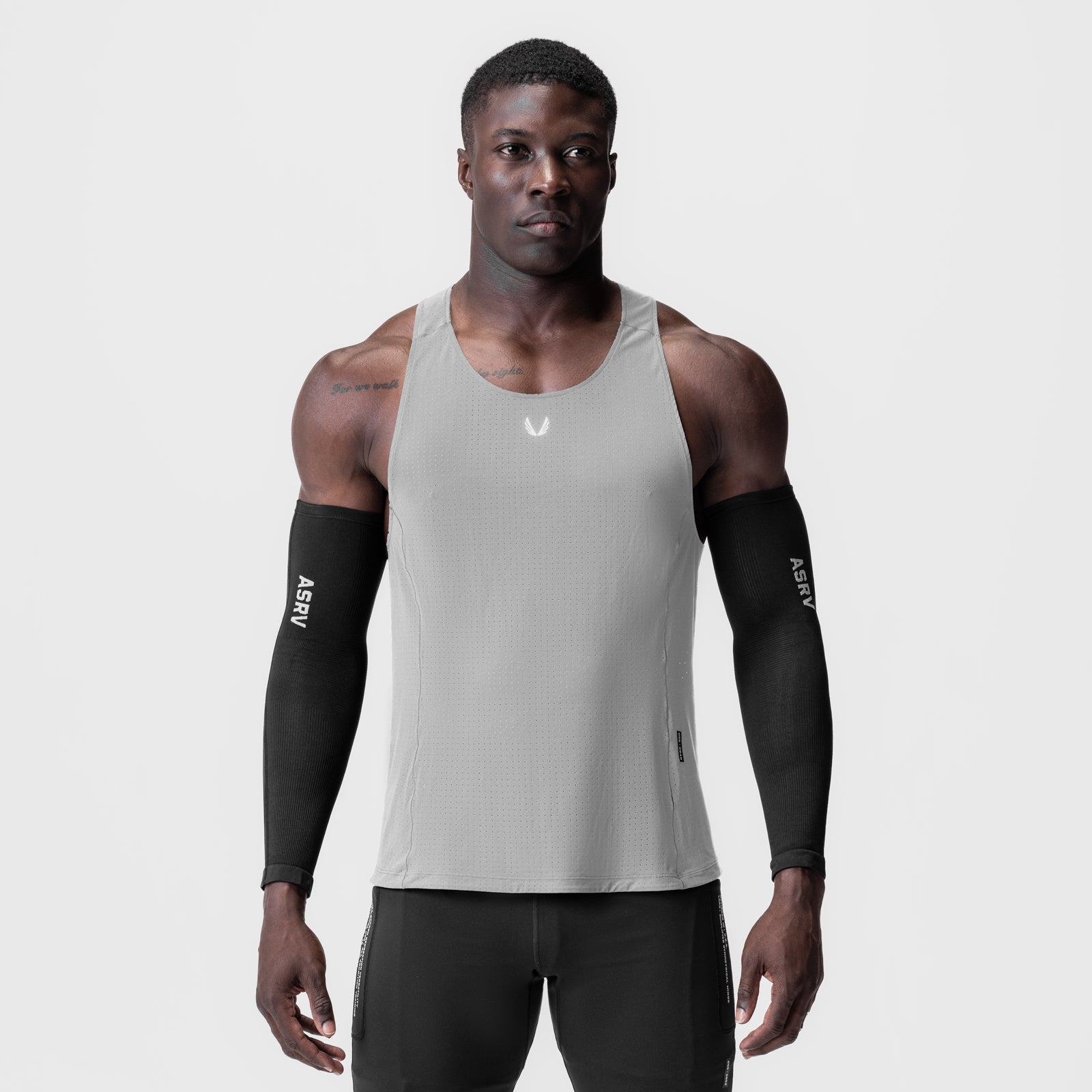 Laser-Vent Singlet Tank in slate grey worn by male model with black arm sleeves, front view