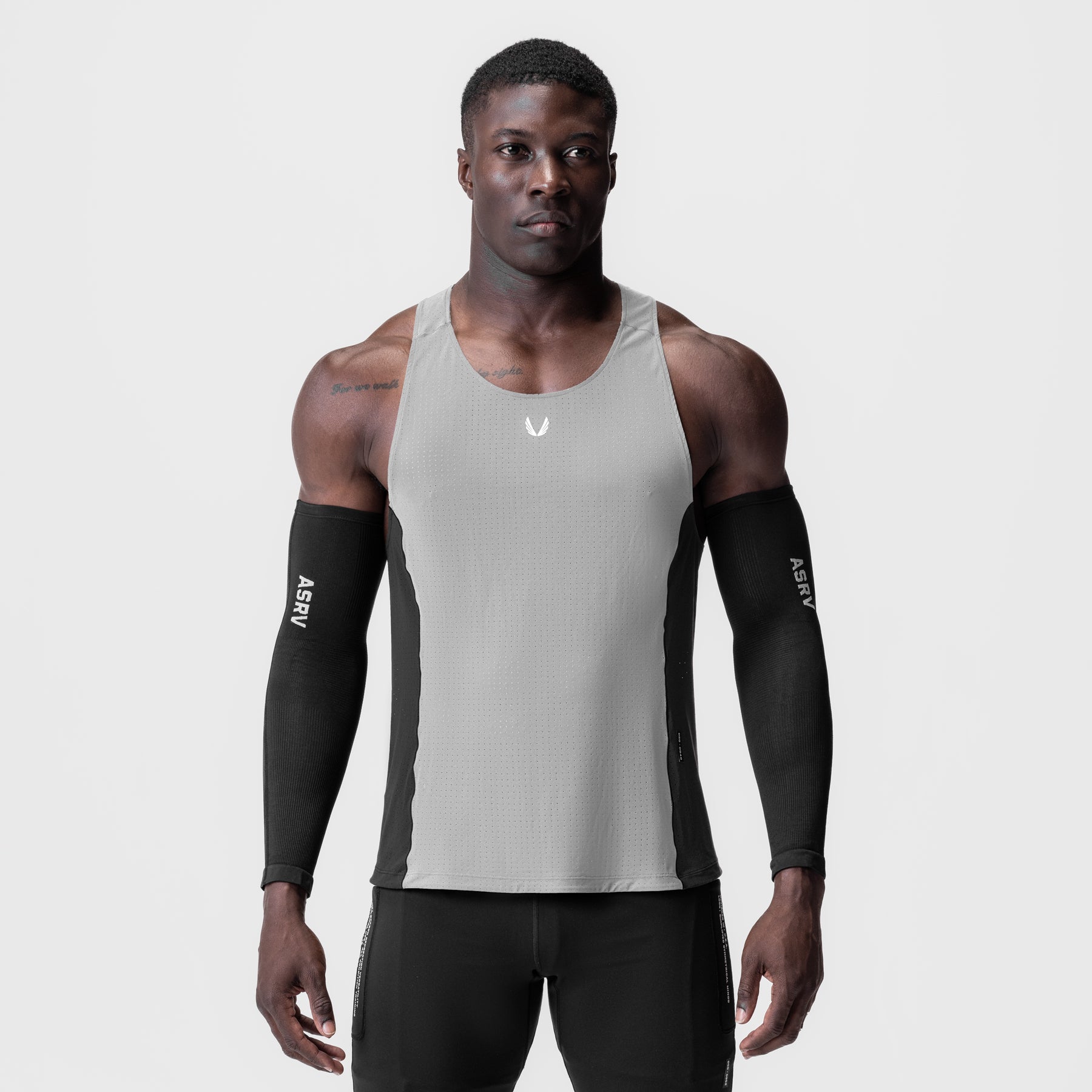 Laser-Vent Singlet Tank in slate grey and black worn with black arm sleeves, front view