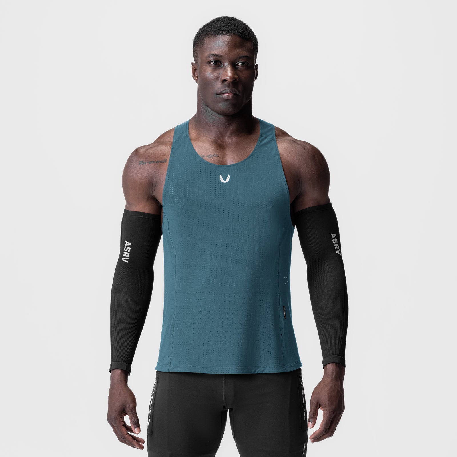 Laser-Vent™ Singlet Tank in storm blue worn by male model with black arm sleeves, front view