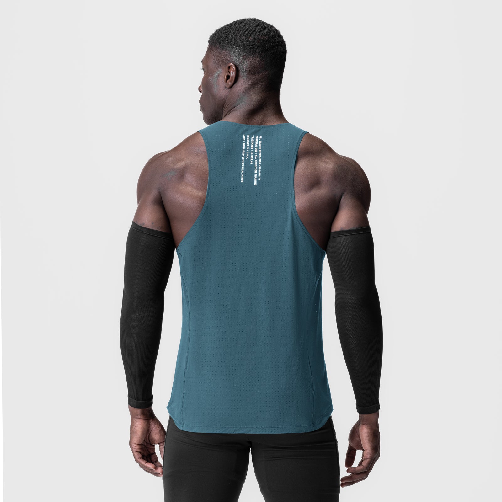 Laser-Vent™ Singlet Tank in storm blue, worn by model showing back view with arm sleeves