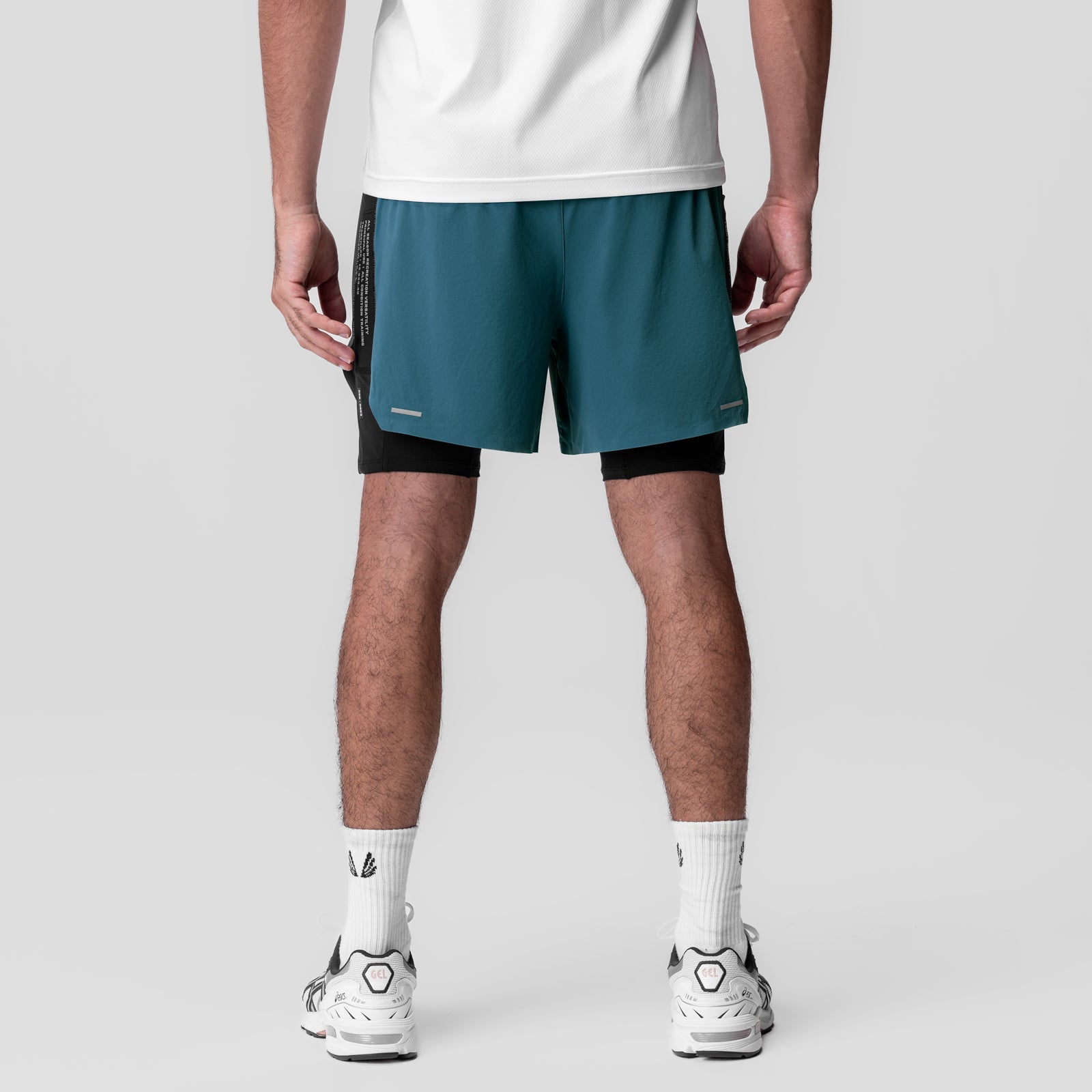 Aerotex Hybrid Liner Short in storm blue and black, worn by model from waist down