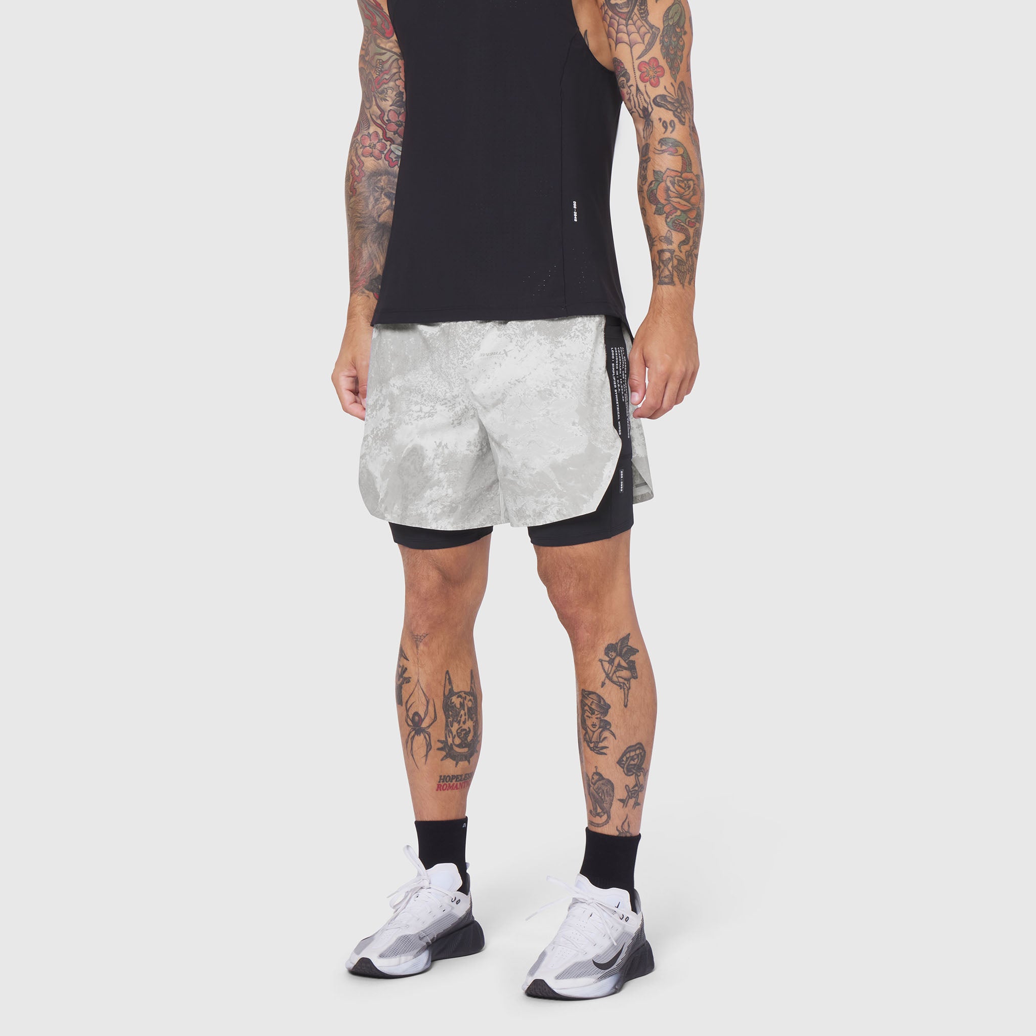Aerotex Hybrid Liner Short in white camo with black liner, worn by model with tattoos