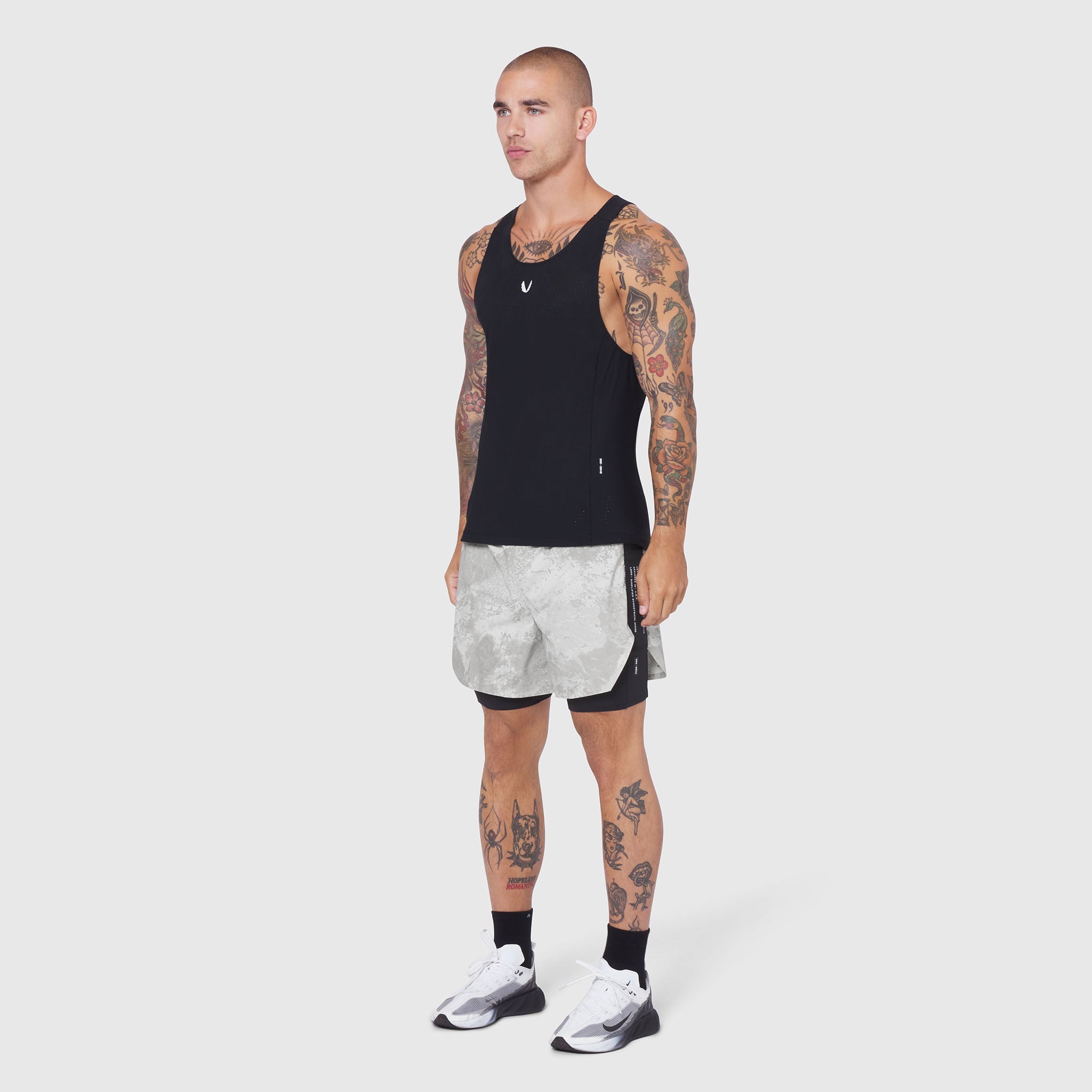 Aerotex Hybrid Liner Short in white Realtree pattern, modeled front view with black tank top