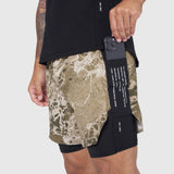 Aerotex Hybrid Liner Short in khaki Realtree camo with black liner, worn by model holding phone
