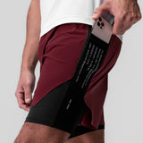 Aerotex Hybrid Liner Short in Crimson/Black, model holding phone in pocket, side view