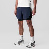 Aerotex Hybrid Liner Short in navy and black, worn by model, front view