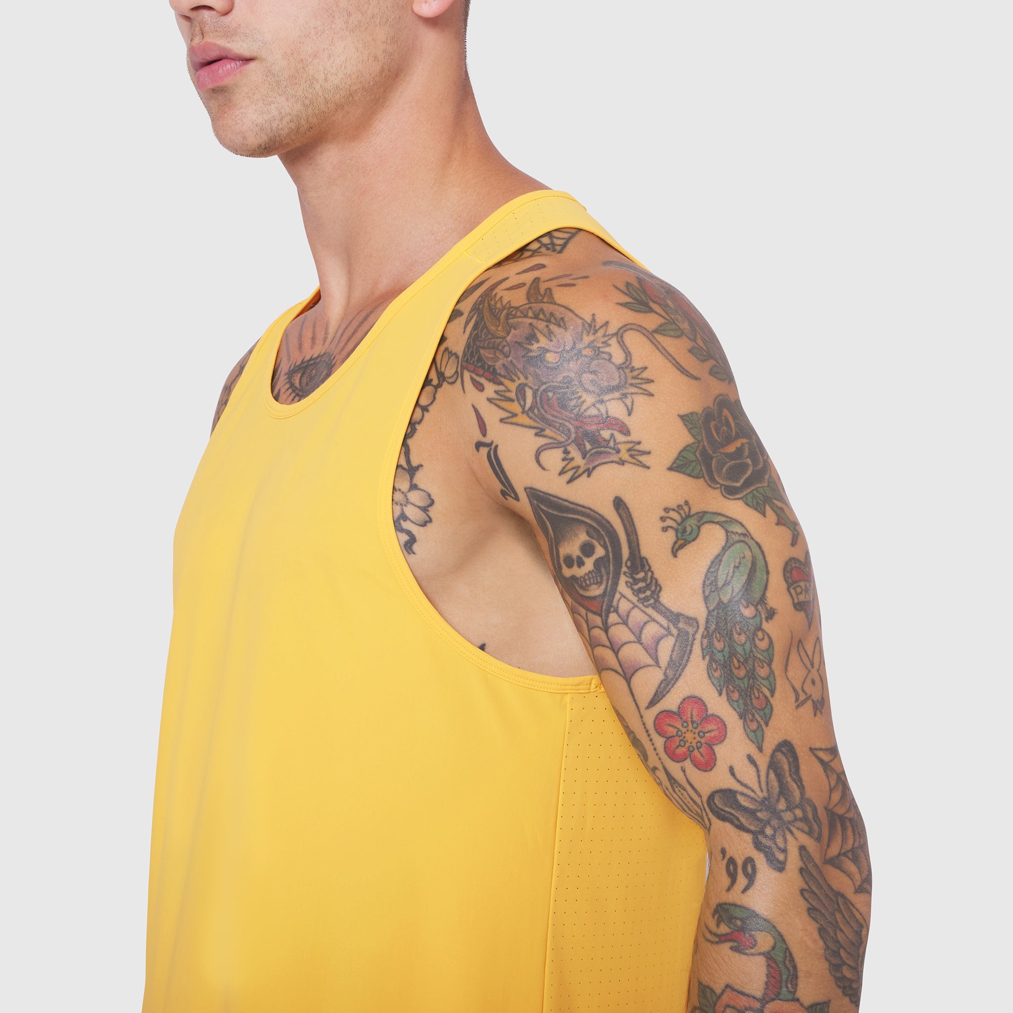 Laser-Vent™ Tank Top in Amber worn by model, side view showcasing tattoos