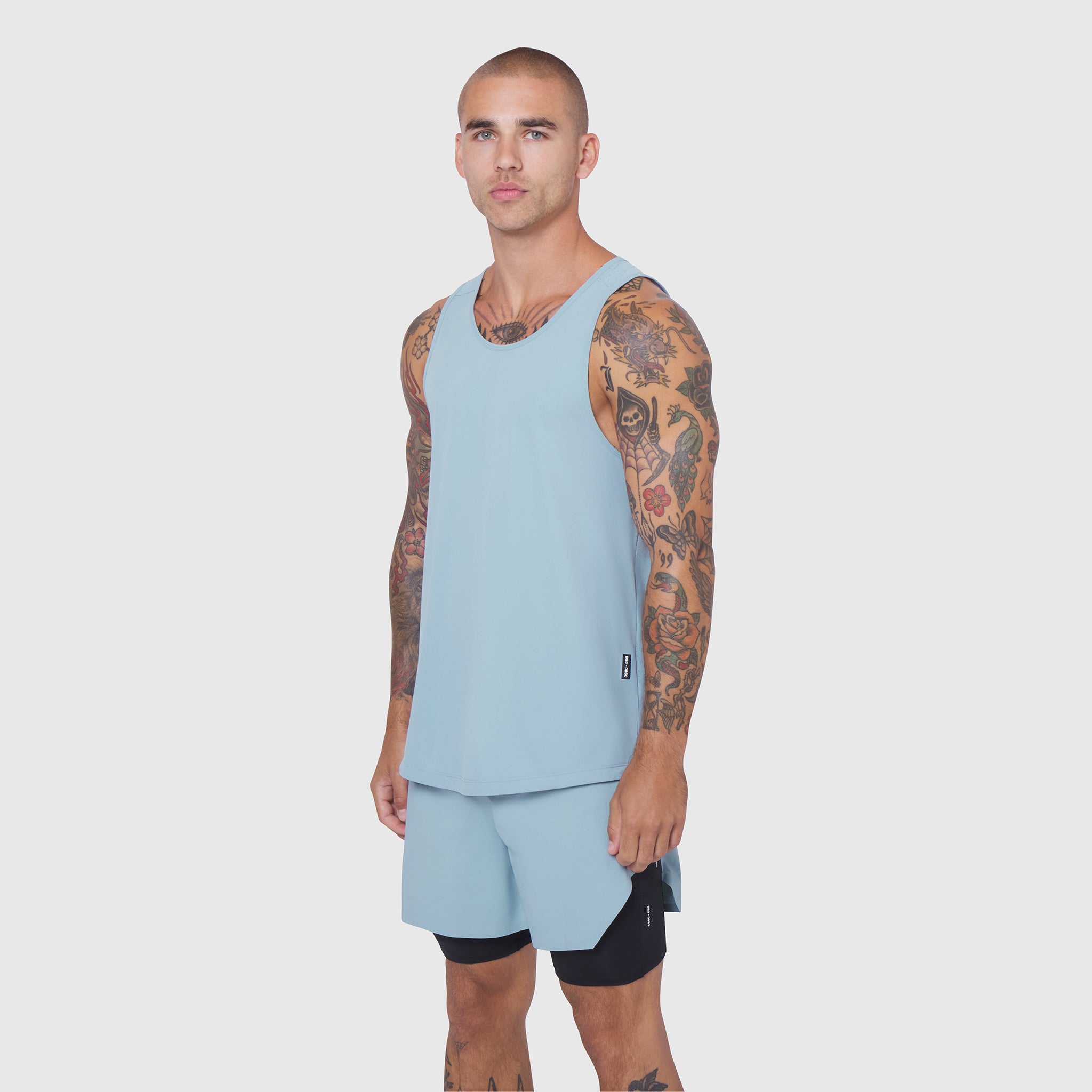 Laser-Vent™ Tank Top in Light Sky worn by male model with matching shorts, front view