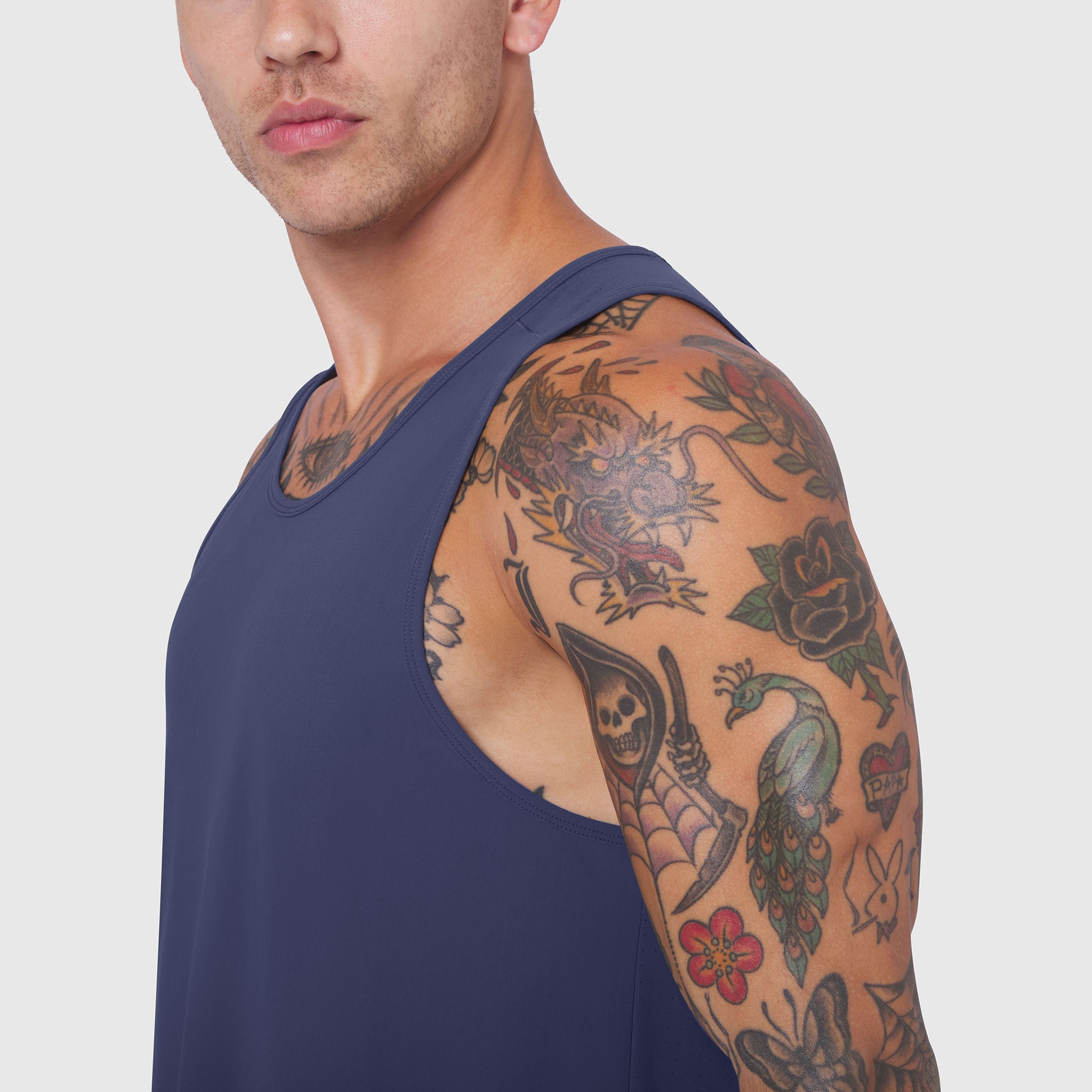 Navy Laser-Vent Tank Top worn by male model showing side view with visible tattoos